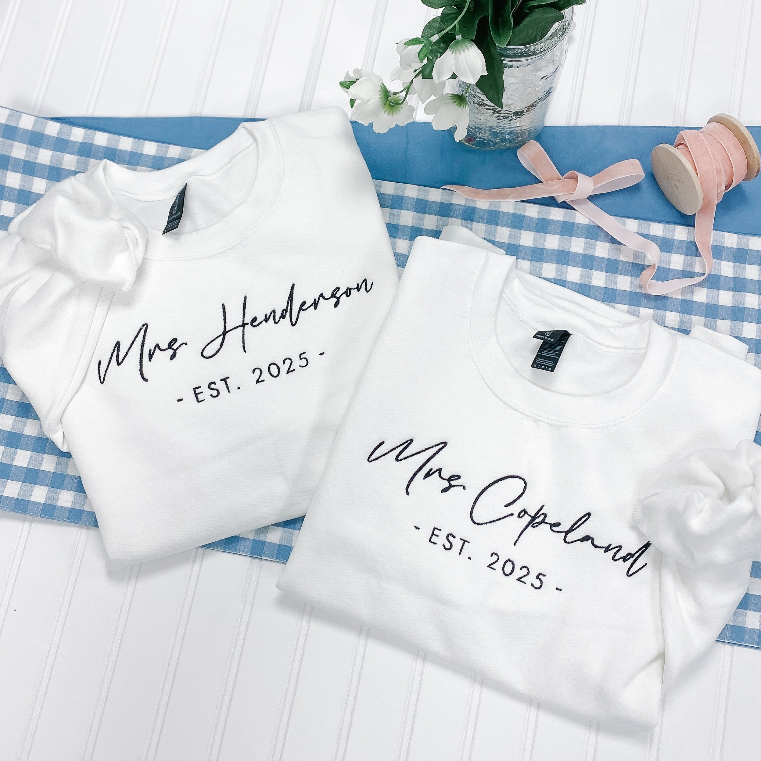 Flatlay of personalized bride gifts sweatshirts