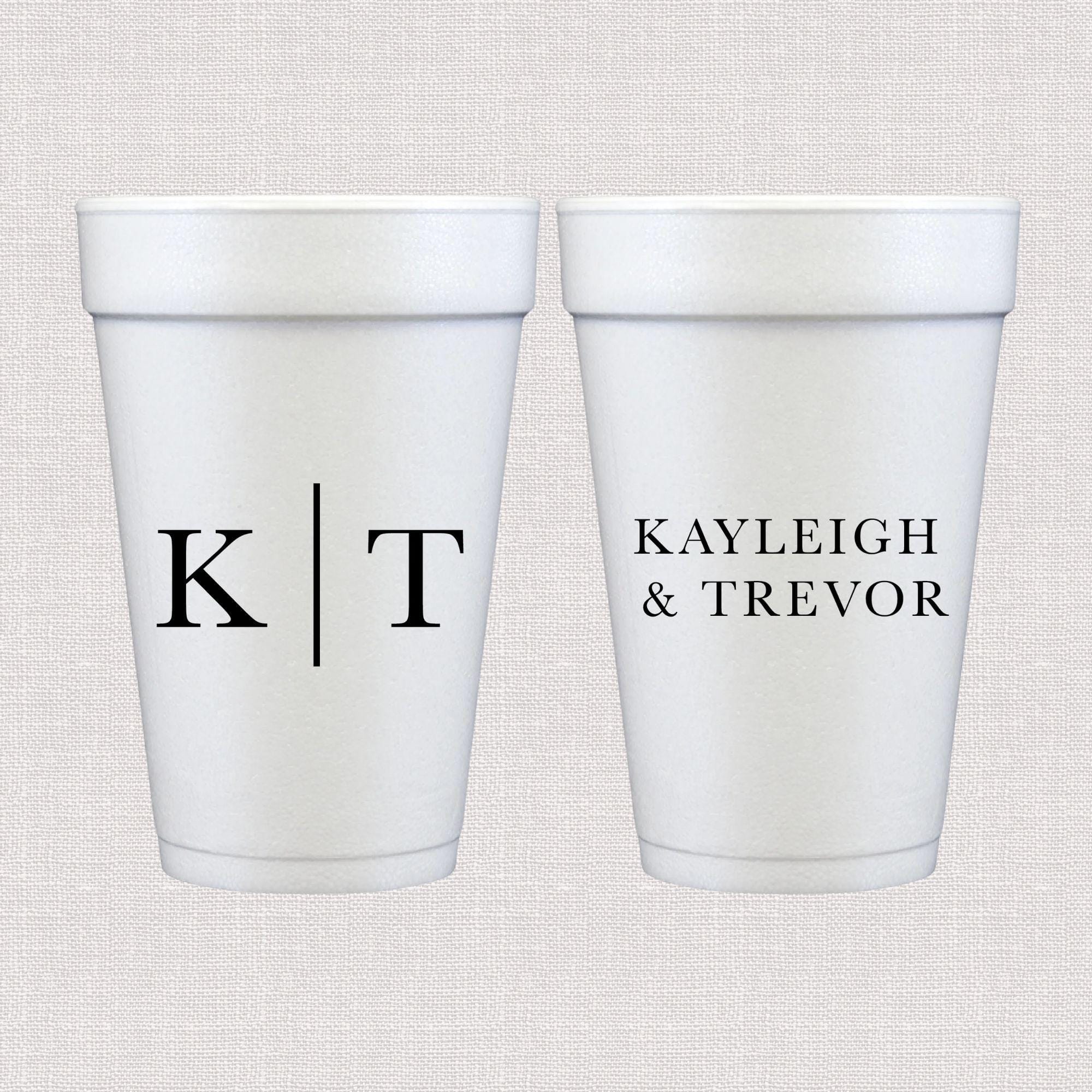 Two white foam cups with black personalized text: initials "K|T" on one cup and "KAYLEIGH & TREVOR" on the other.