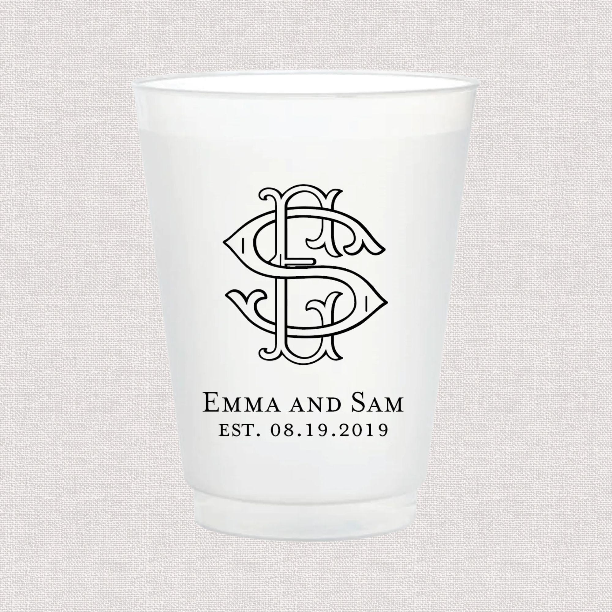 Frosted white cup with decorative interlocked monogram and "Emma and Sam EST. 08.19.2019" text