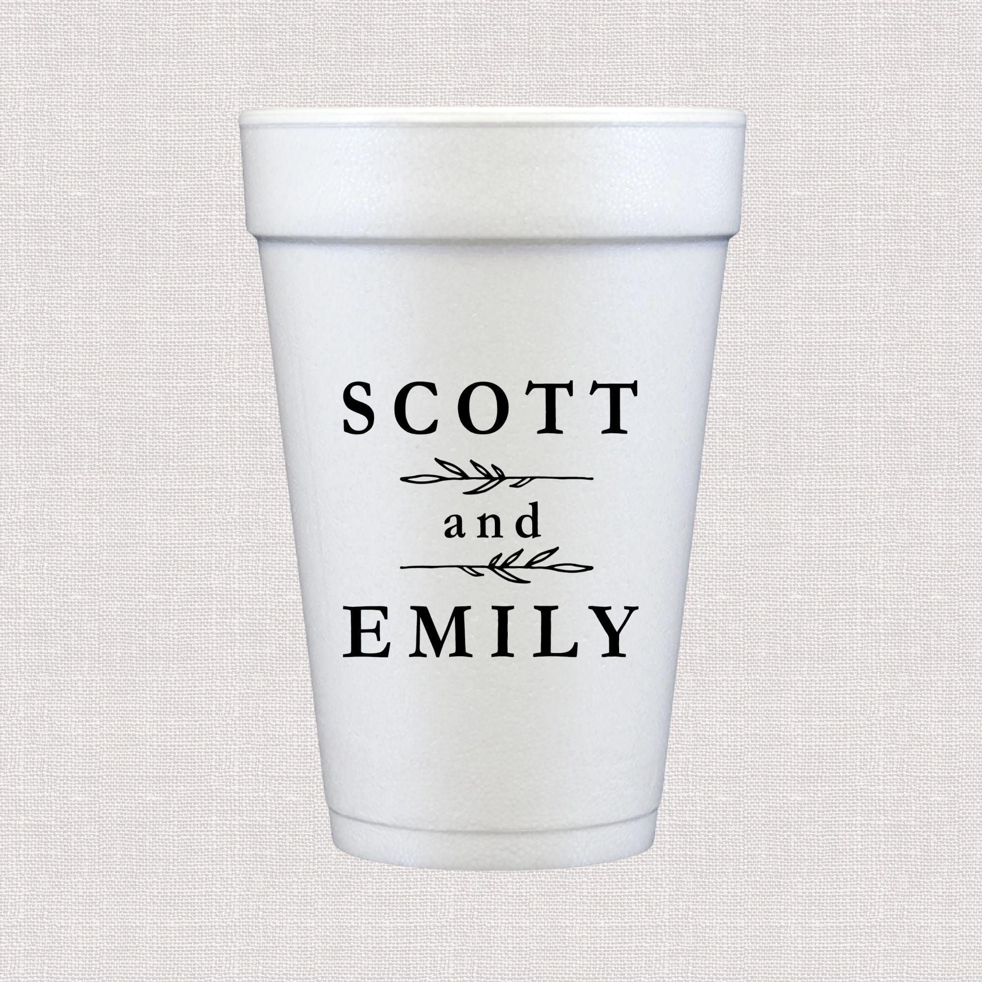 White foam cup personalized with "Scott and Emily" in black text with decorative leaf design between names