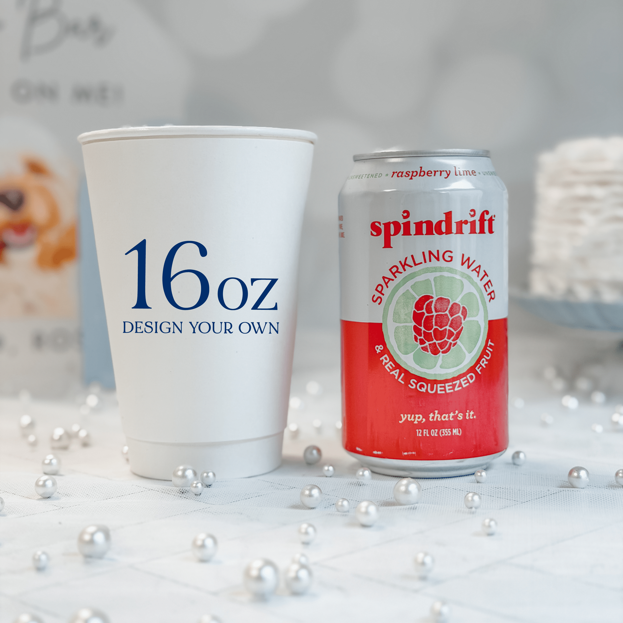 16 oz white paper cup next to a 12 oz soda can for scale, personalized custom design