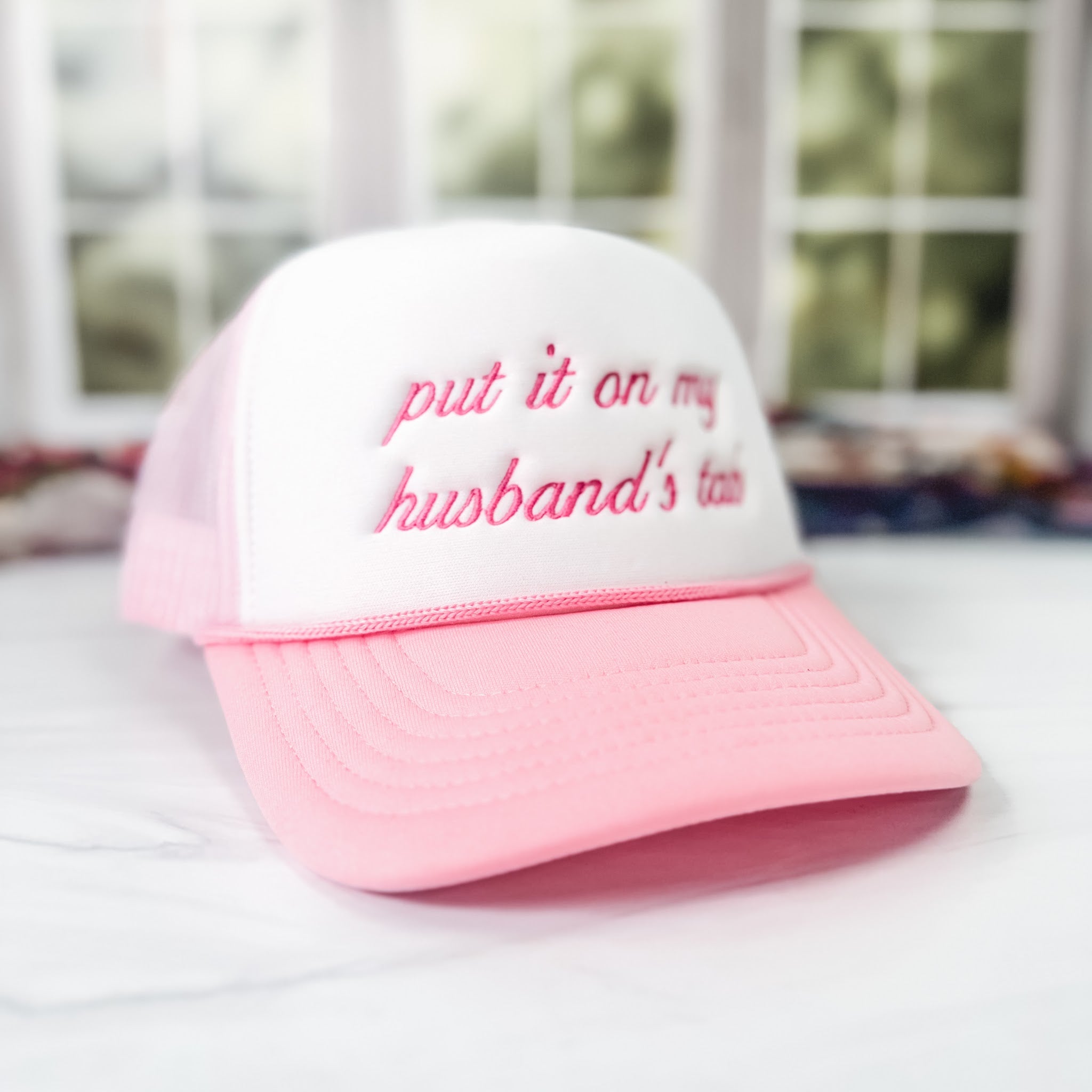 Pink bachelorette trucker hat with put it on my husband's tab embroidery