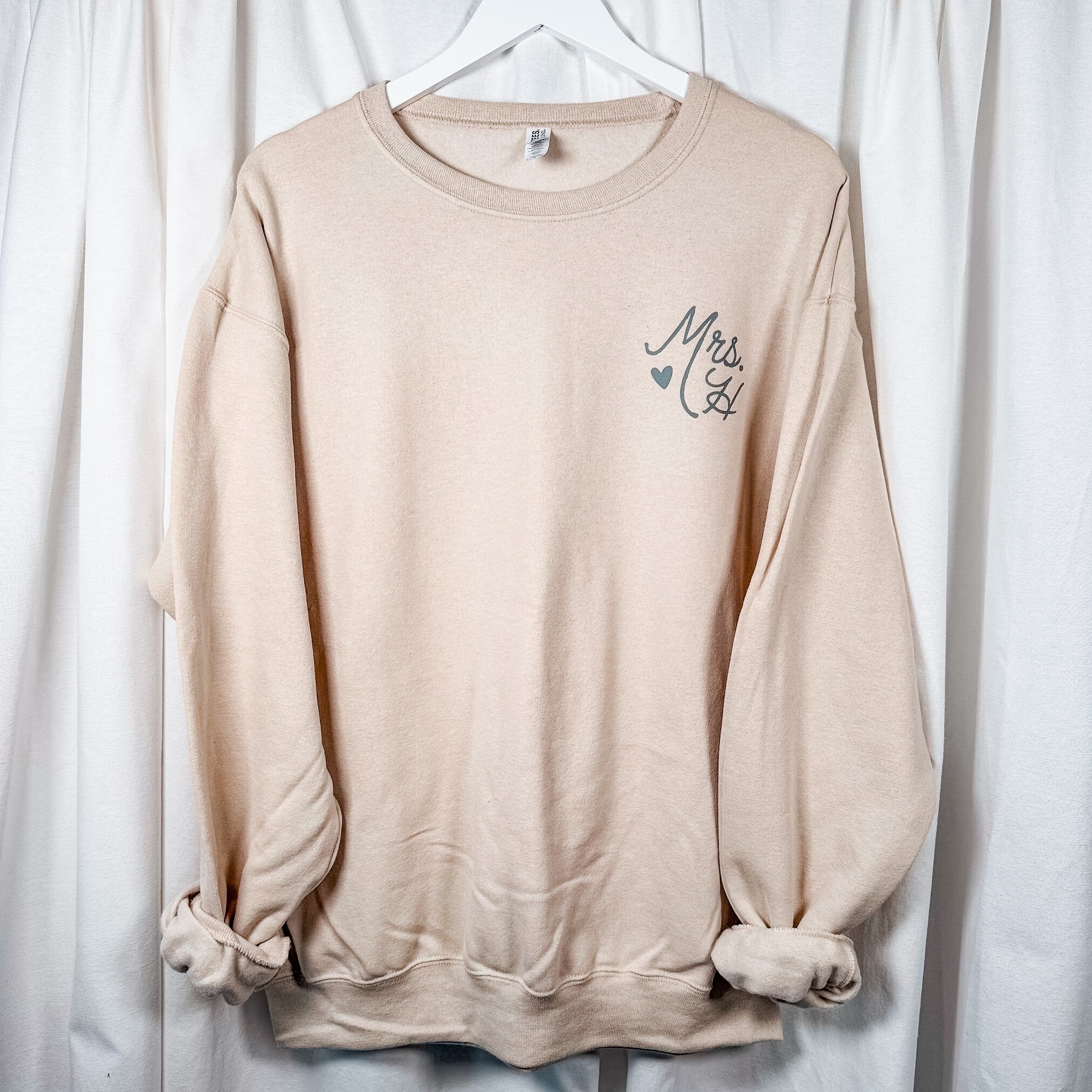 Mrs. last initial crewneck sweatshirt, styled flat lay