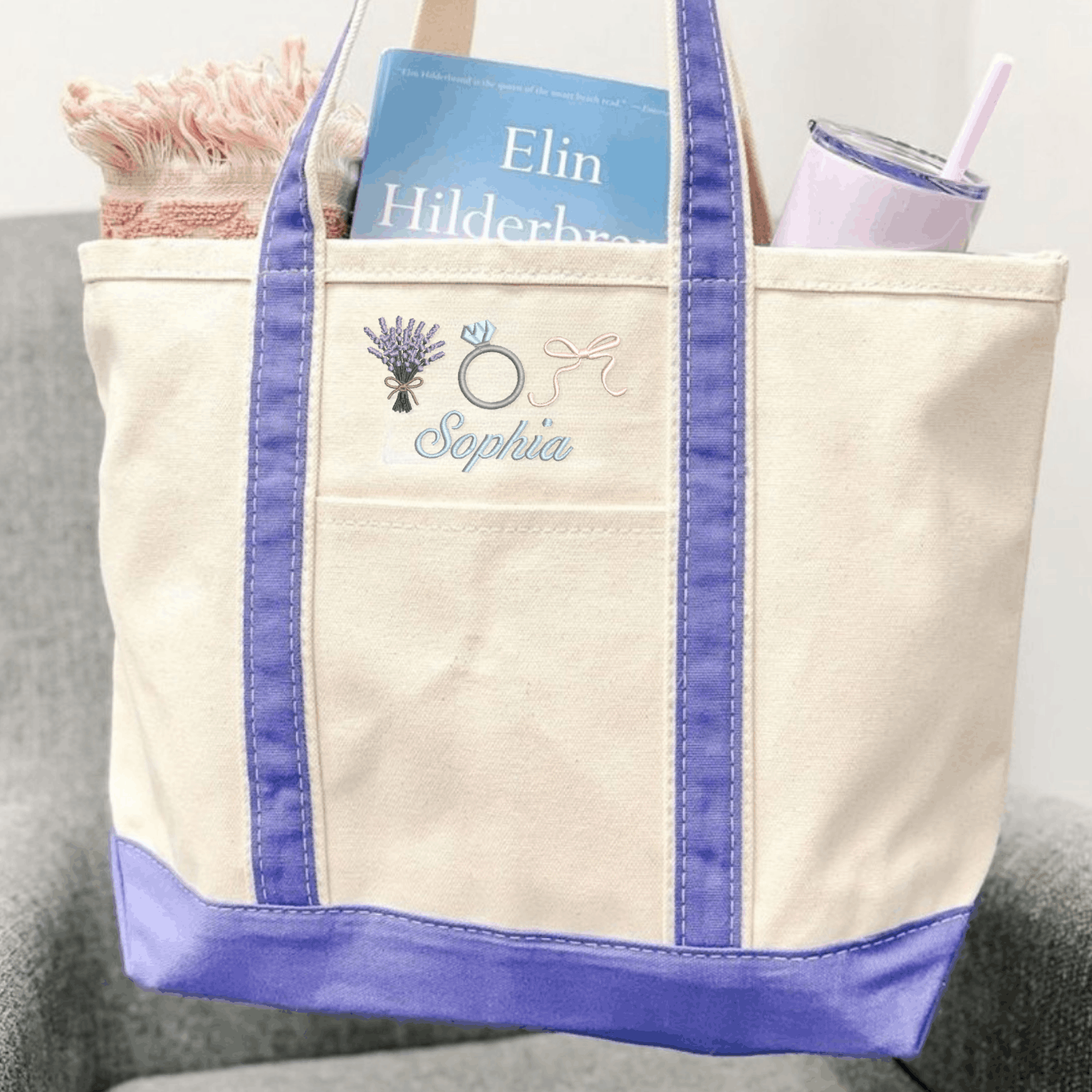 Personalized embroidered canvas tote bag with purple trim, the name Sophia, and lavender, engagement ring, and bow icons.