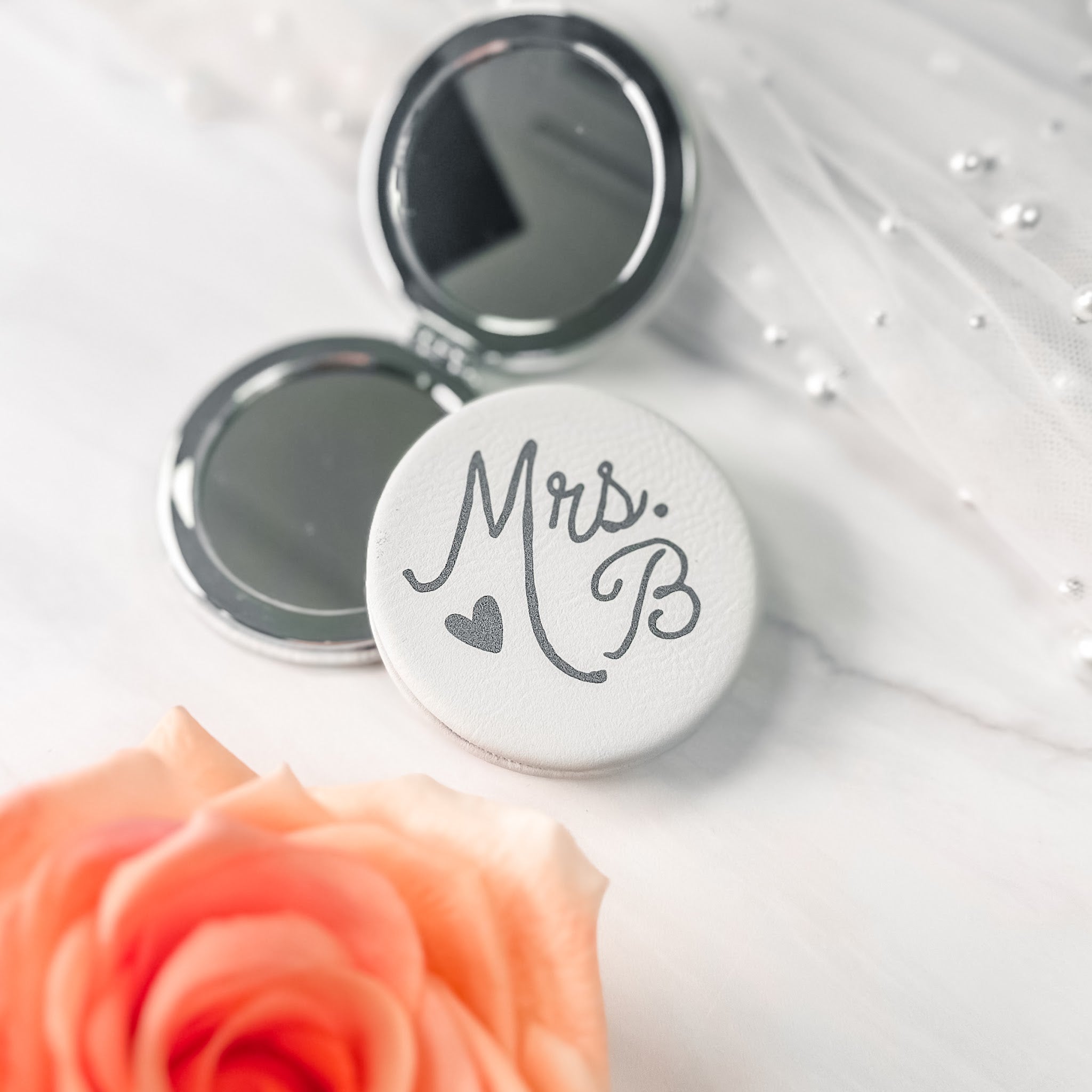 Mrs. bride compact mirror open showing two mirrors, one magnifying