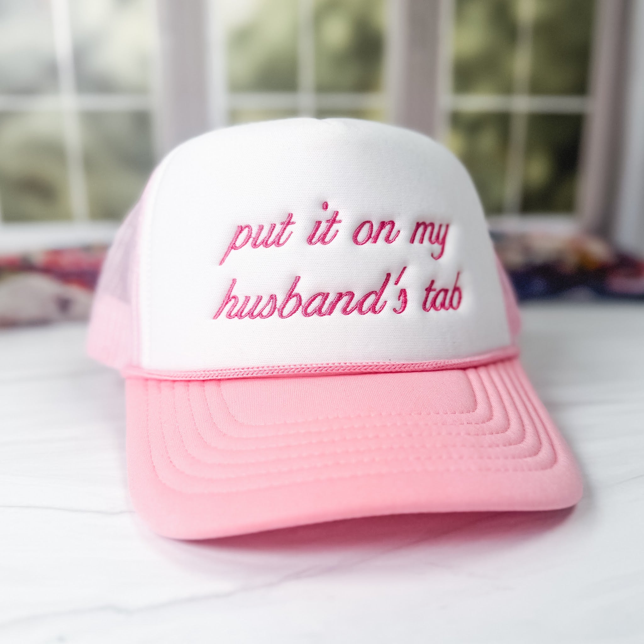 Put it on my husband's tab embroidered foam trucker hat in pink and white