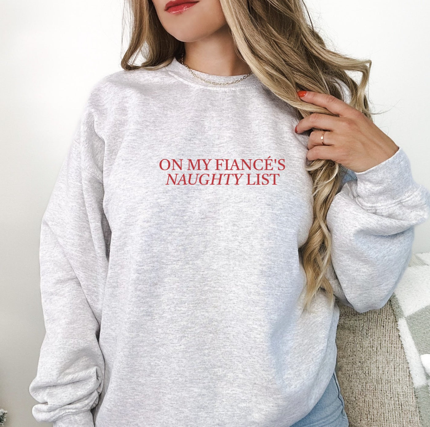 A light grey, long-sleeved crewneck sweatshirt crafted from soft fabric, designed for a bride-to-be or engagement event.
