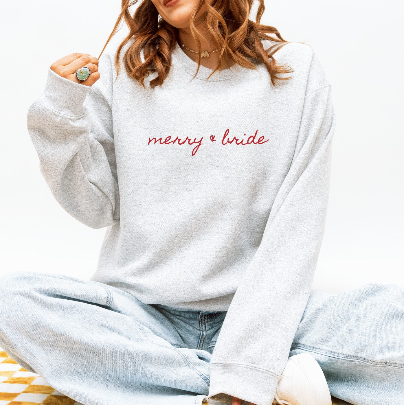 A light grey crewneck sweatshirt made from a soft cotton blend, designed as personalized apparel for a wedding celebration.