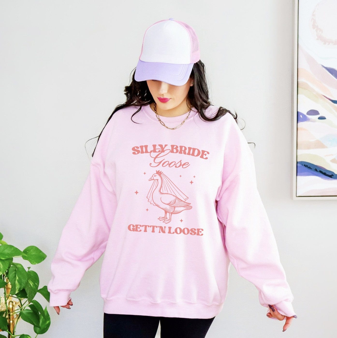 A light pink crewneck sweatshirt featuring a graphic of a goose wearing a bridal veil and crown, designed for a bridal event.