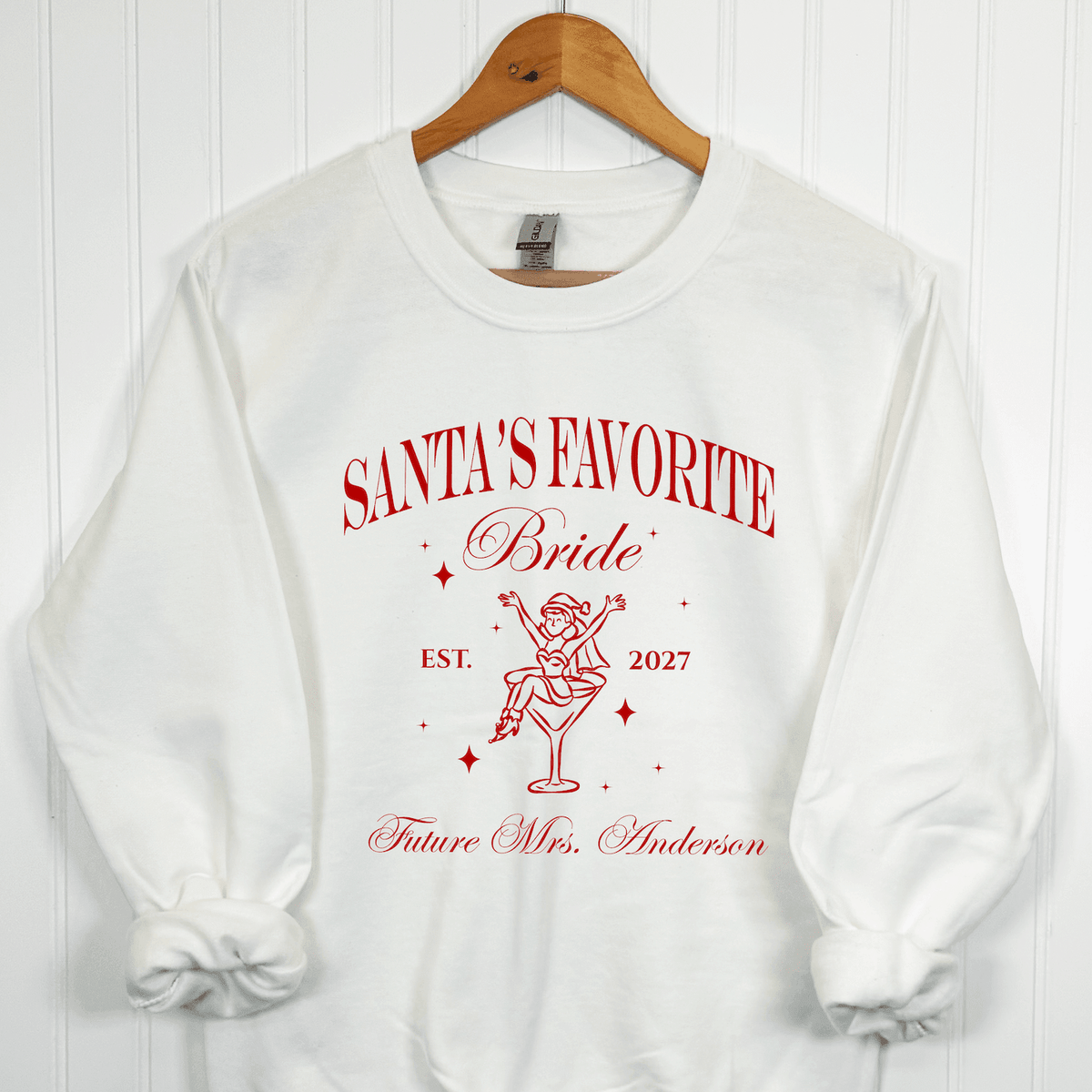 White personalized Santa's Favorite Bride Christmas sweatshirt with red vintage bridal design, custom wedding year and future last name.