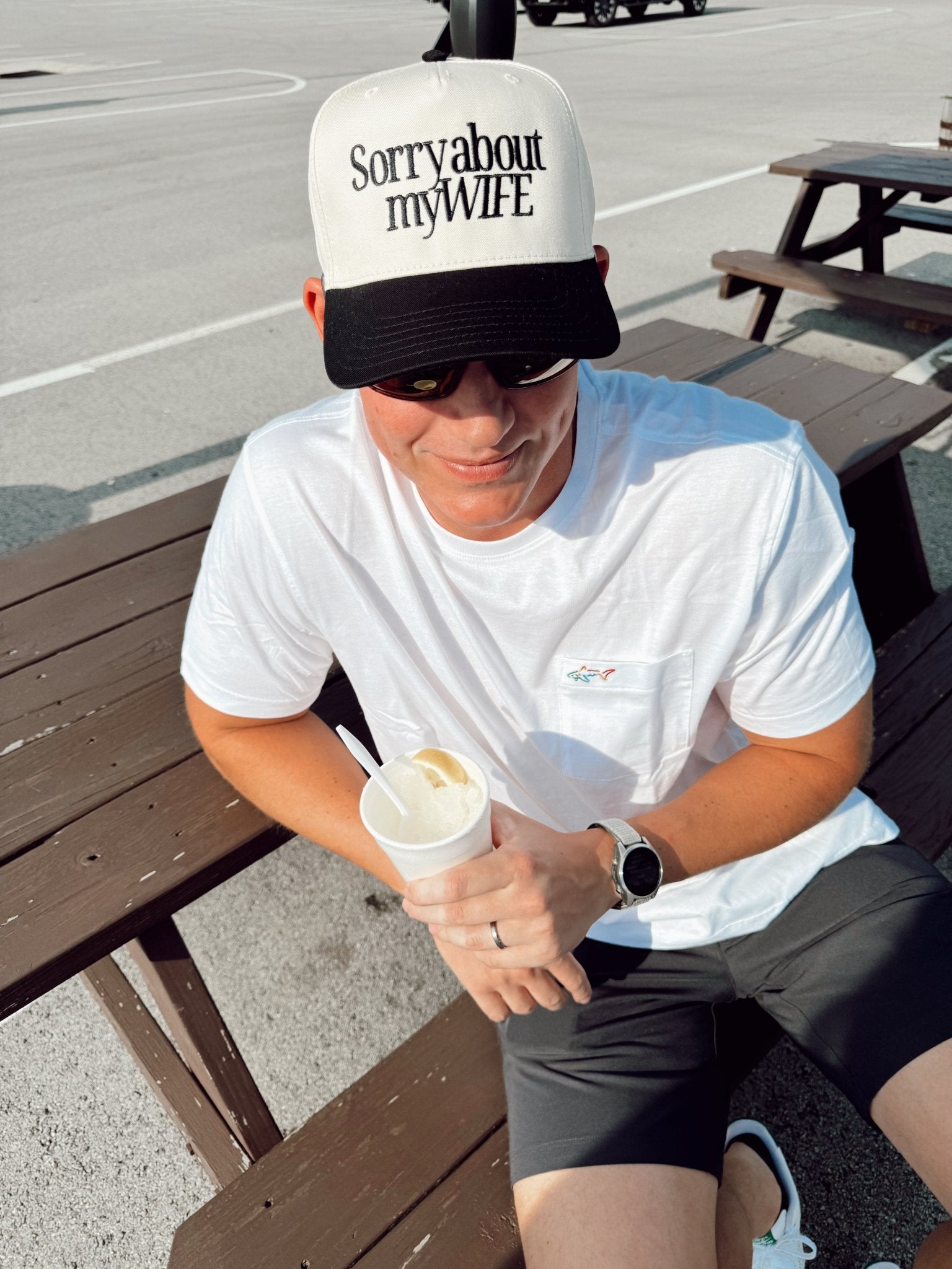 White and black vintage trucker hat with "Sorry about my WIFE" text on front panel