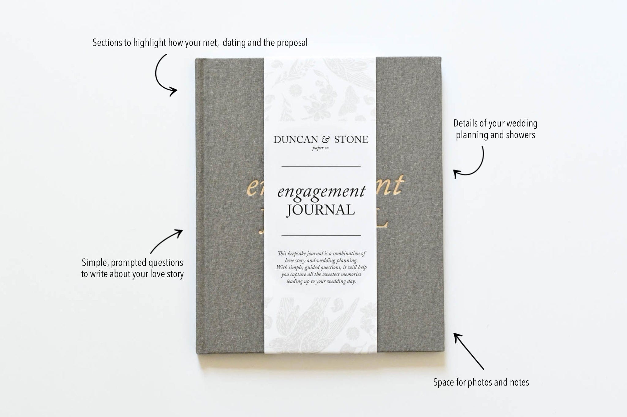 Gray linen couples engagement journal with white marble accents and gold lettering, showing customizable sections for love story details and photos.