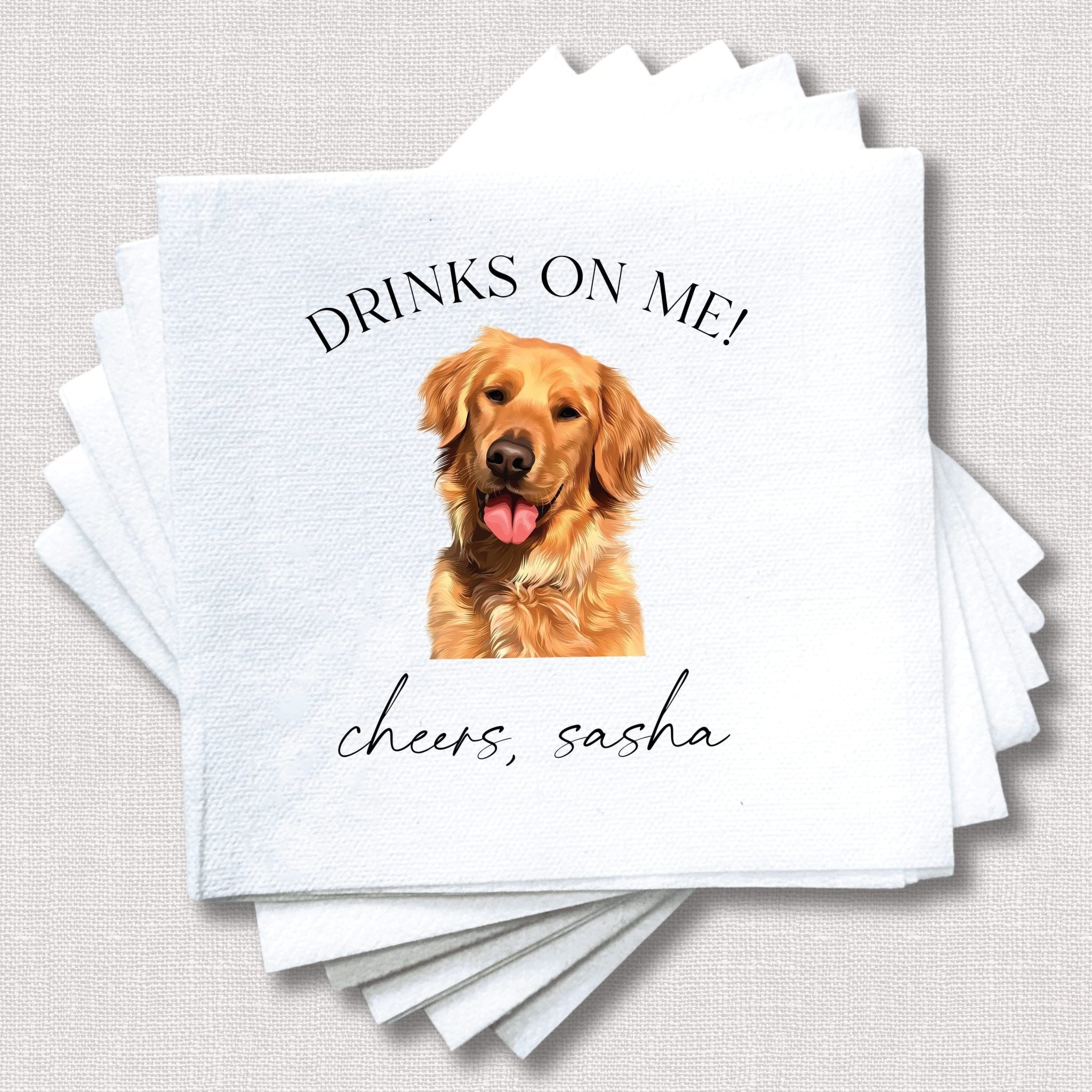 White napkin stack with golden retriever photo, "Drinks on me!" text, and personalized name "cheers, sasha" below dog