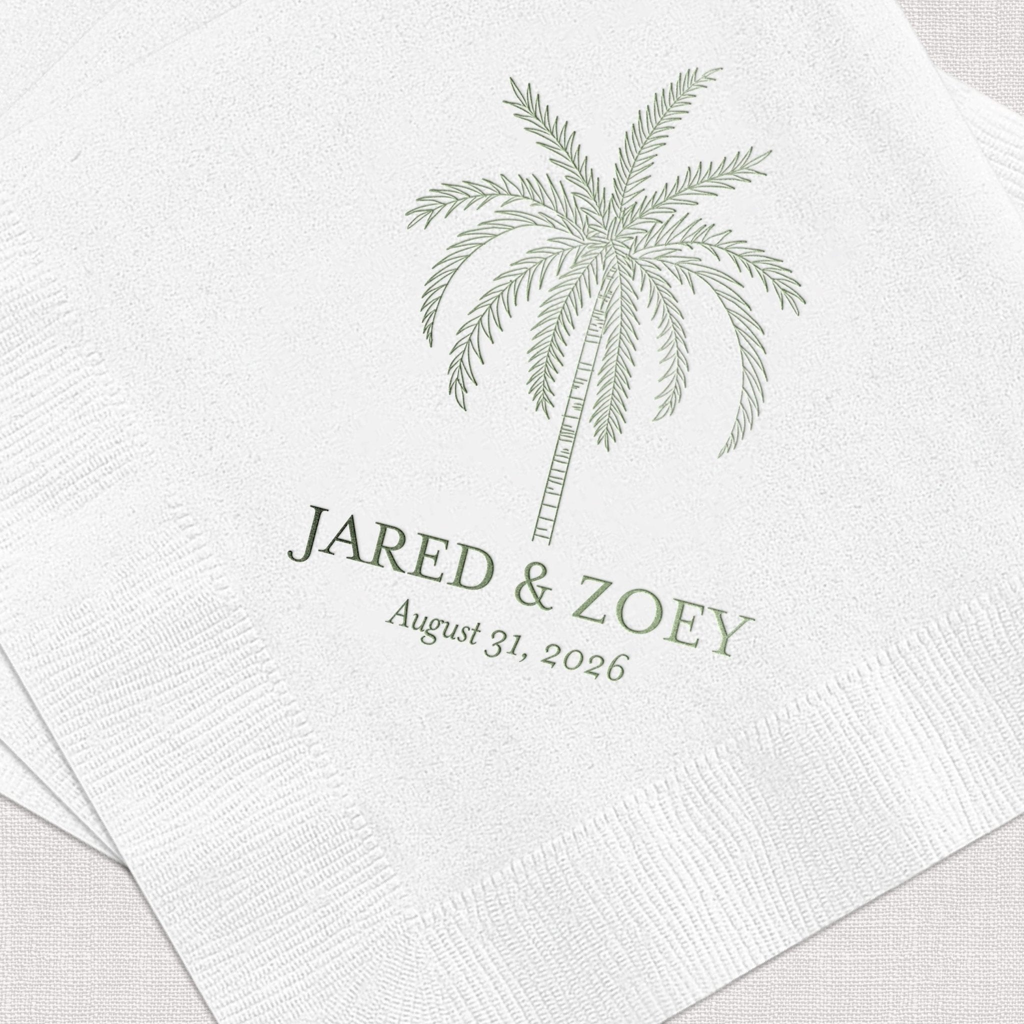 White cocktail napkins with sage green palm tree design and personalized names Jared and Zoey with wedding date August 31, 2026