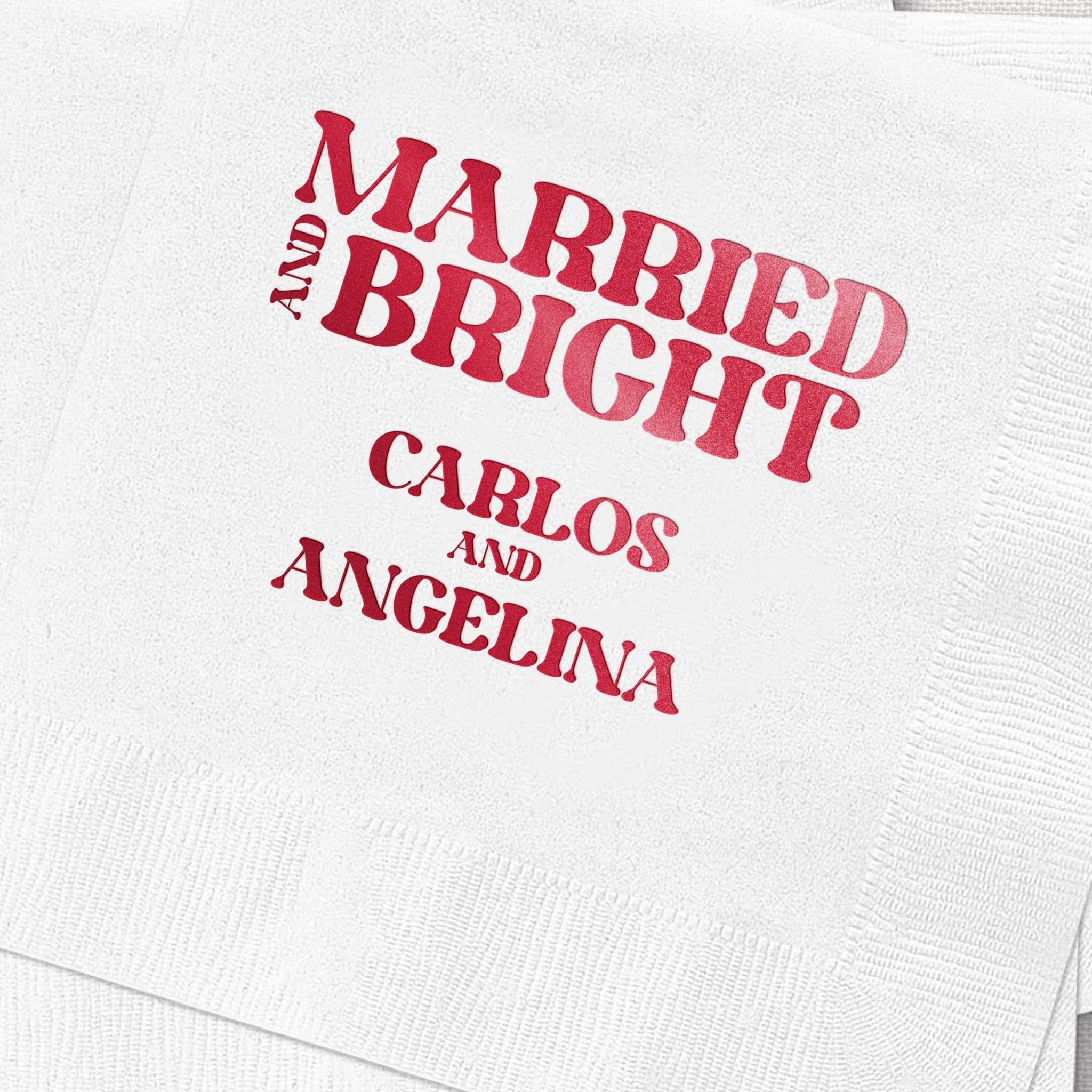 White napkin with hot pink foil stamped text reading "Married and Bright" with couple names Carlos and Angelina below