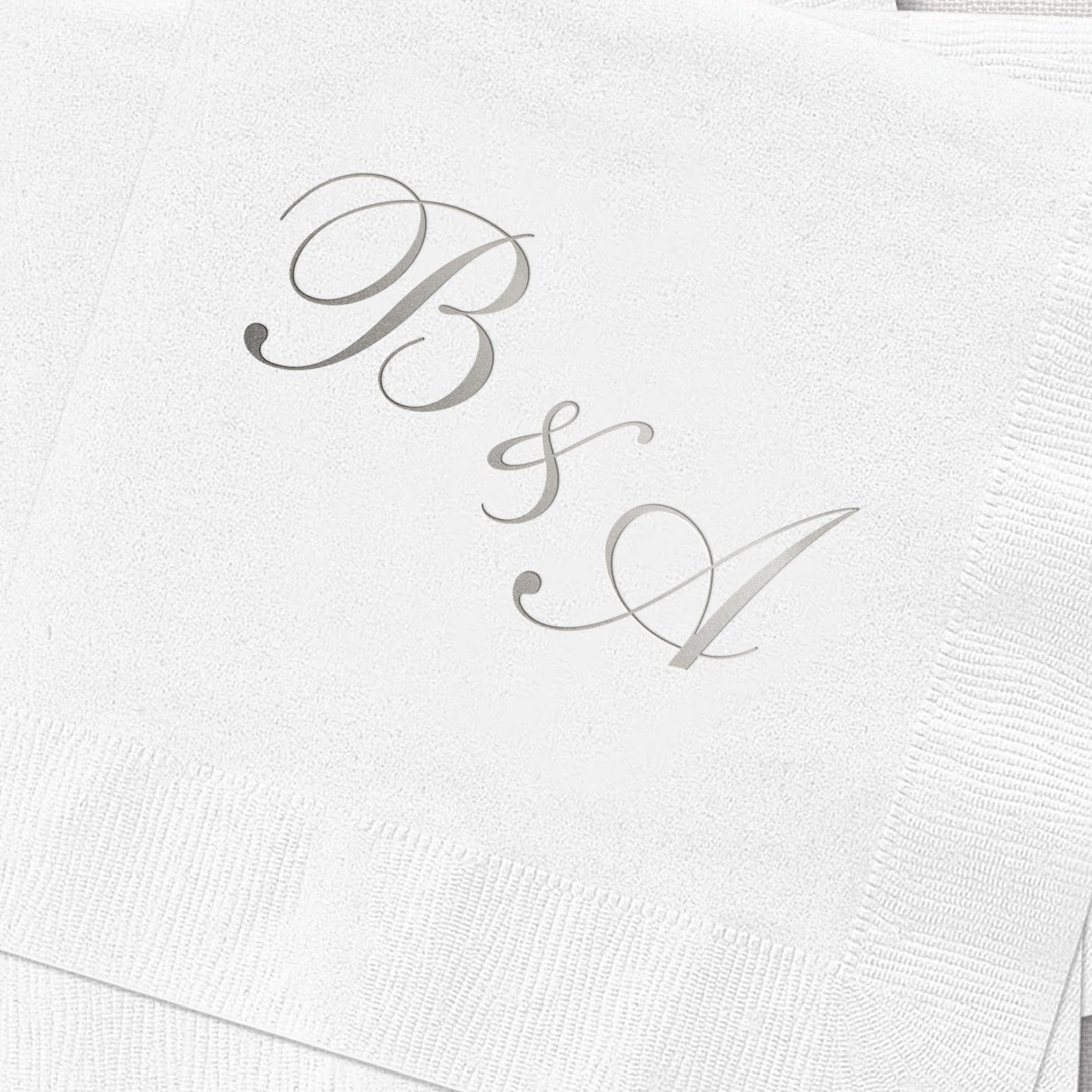 White napkin with elegant gray foil-stamped monogram initials B and L connected with ampersand symbol