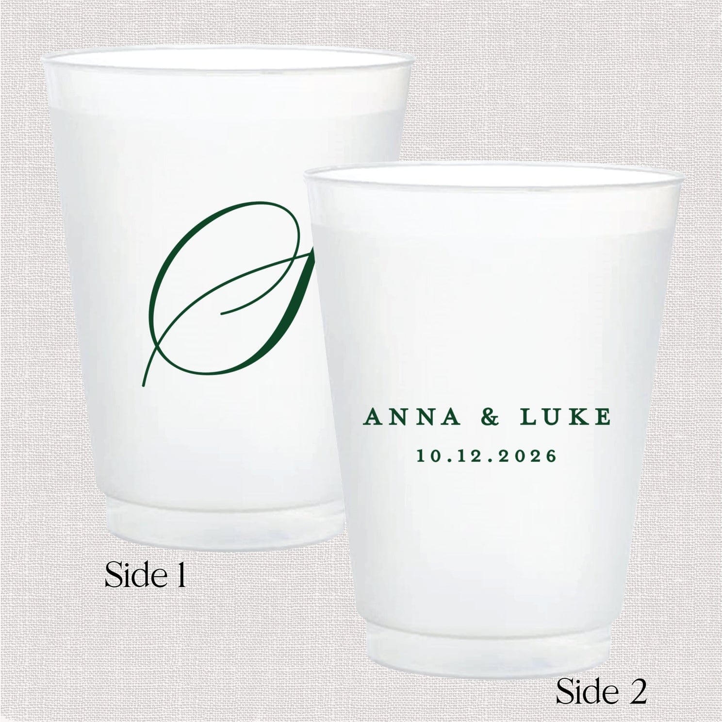 Two white frosted cups with green monogram leaf design on front and personalized names "Anna & Luke" with date "10.12.2026" on back