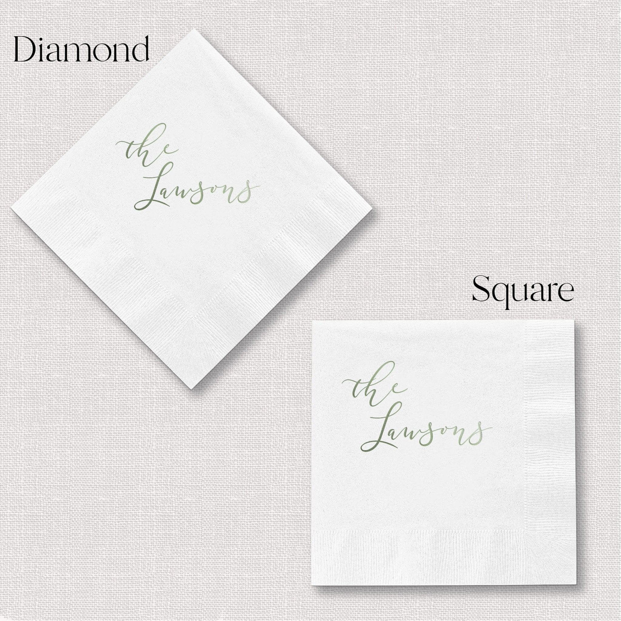 White napkins in diamond and square shapes with "the Lawsons" in silver script lettering