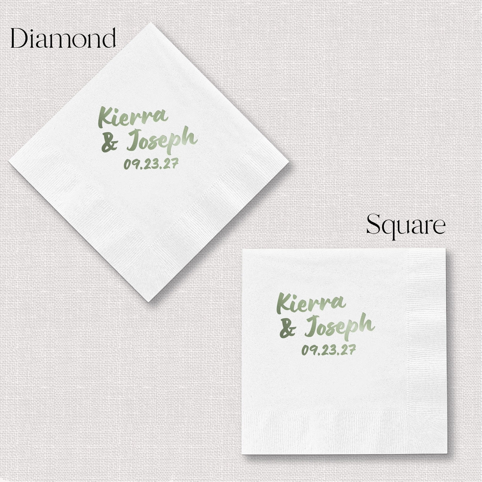 White cocktail napkins with personalized names and wedding date in sage green foil lettering, shown in diamond and square fold styles.