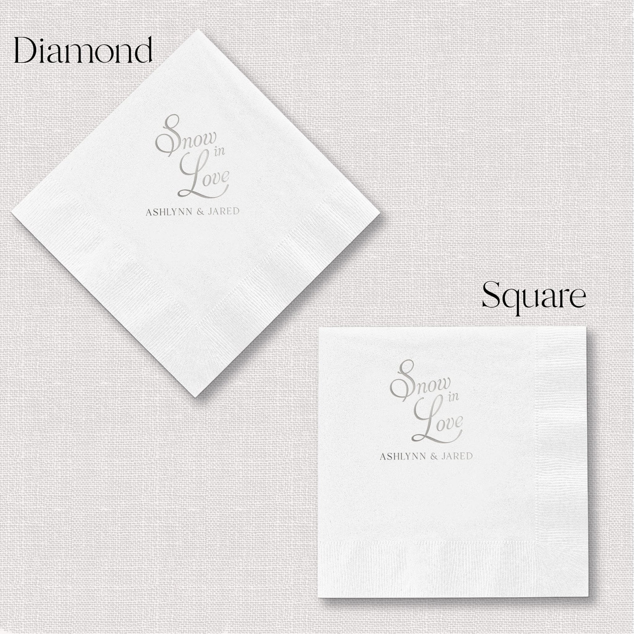 White napkins in diamond and square shapes with "Snow In Love" and personalized names in foil stamped text
