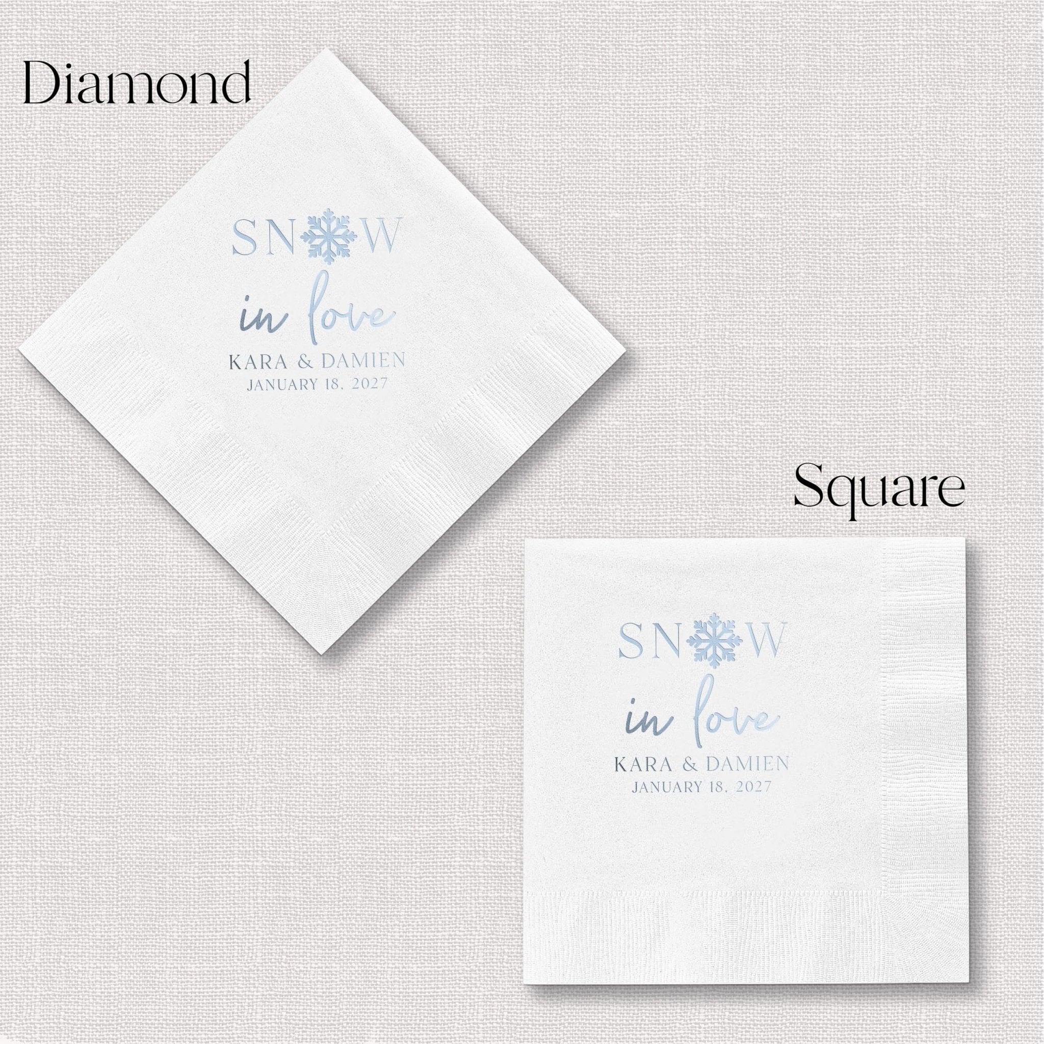 White napkins with "Snow in Love" text and snowflake design in blue foil, personalized with couple names and wedding date