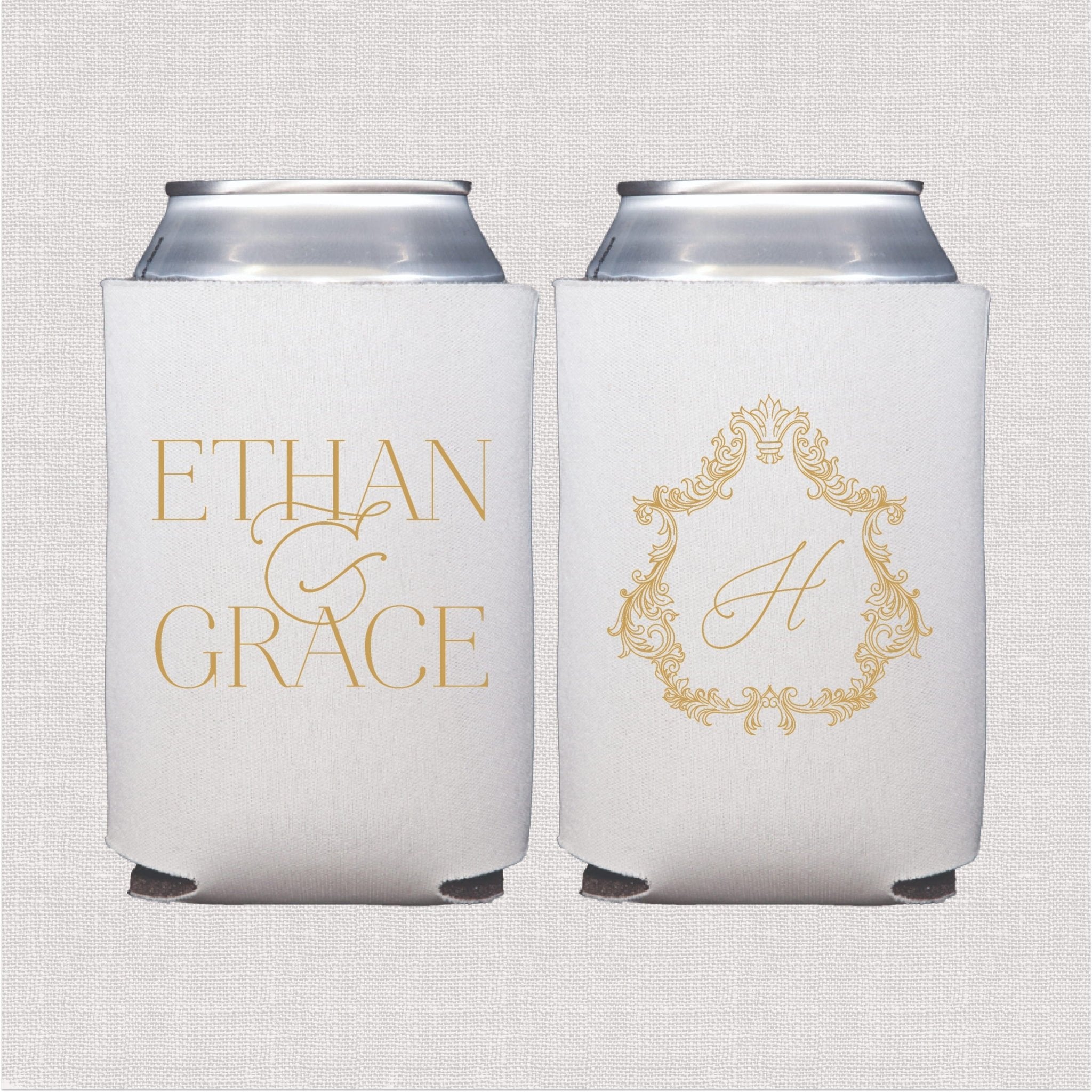 Two white can coolers with gold text reading "Ethan & Grace" and a monogrammed "A" inside an ornate baroque frame design.