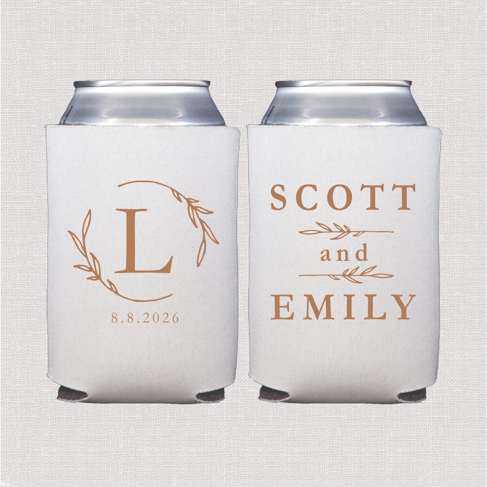 Pair of white can coolers with gold foil wreath monogram and "Scott and Emily" wedding date 8.8.2026