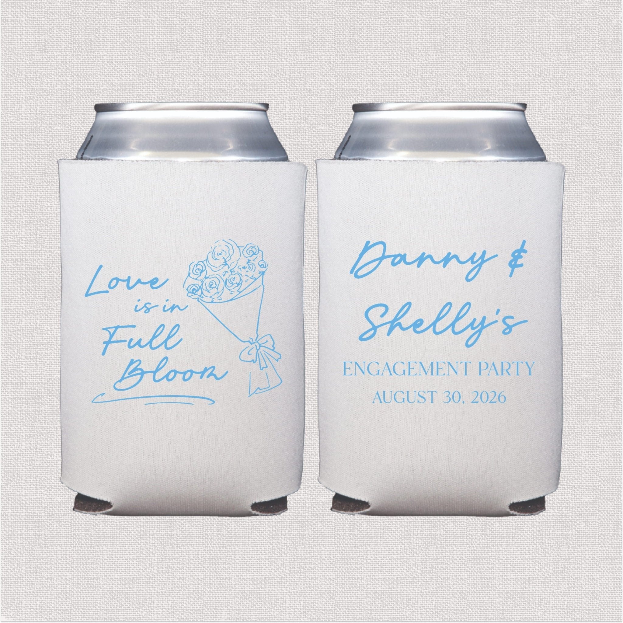 Pair of white neoprene can coolers with blue script text reading "Love is in Full Bloom" and "Danny & Shelly's Engagement Party August 30, 2026" with floral design.