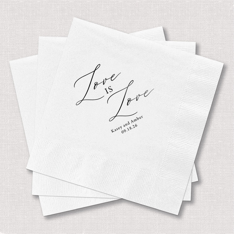 White foil-stamped napkins with "Love is Love" script and personalized names and date underneath