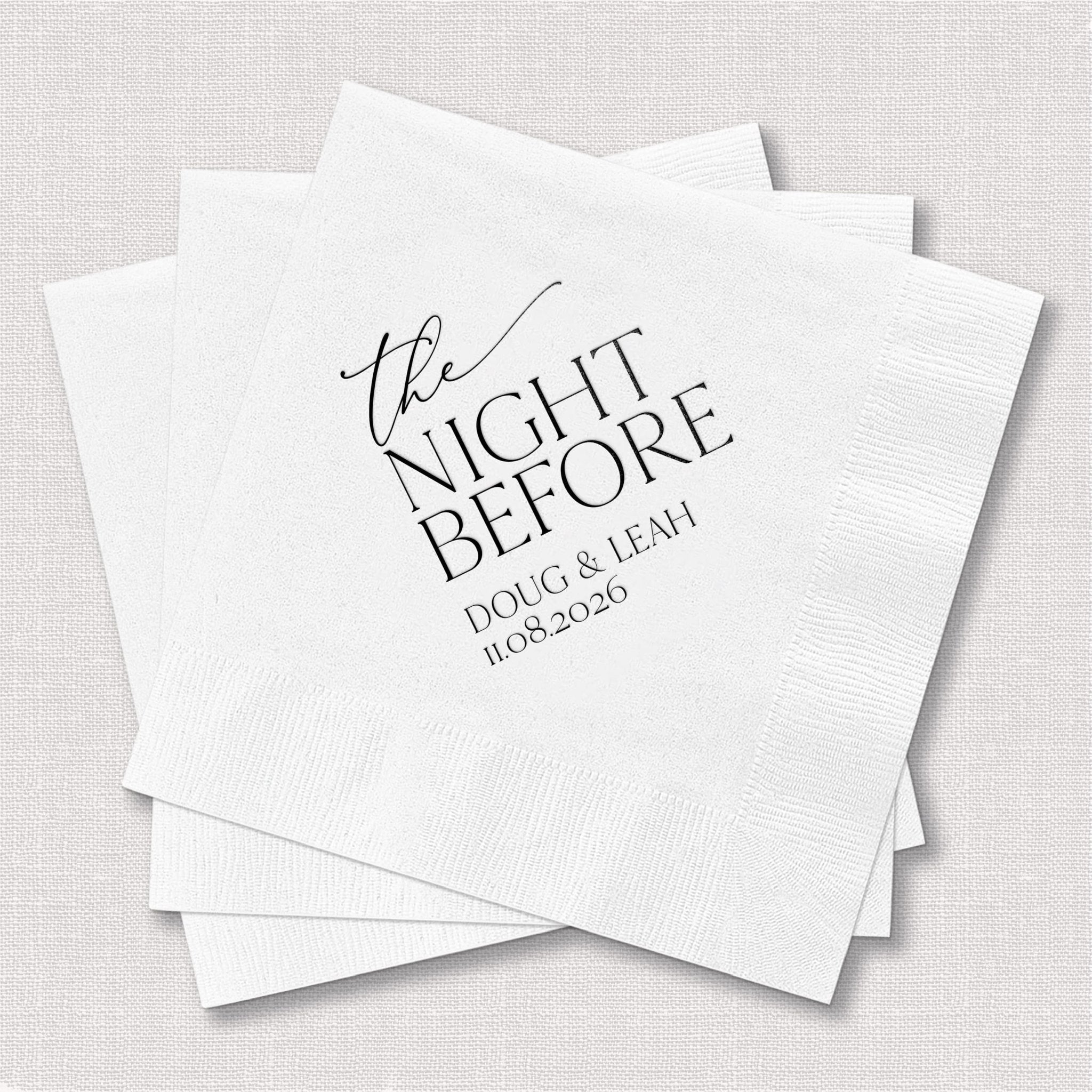 Stack of white personalized napkins with "the NIGHT BEFORE" text and couple names and date in foil stamped design.