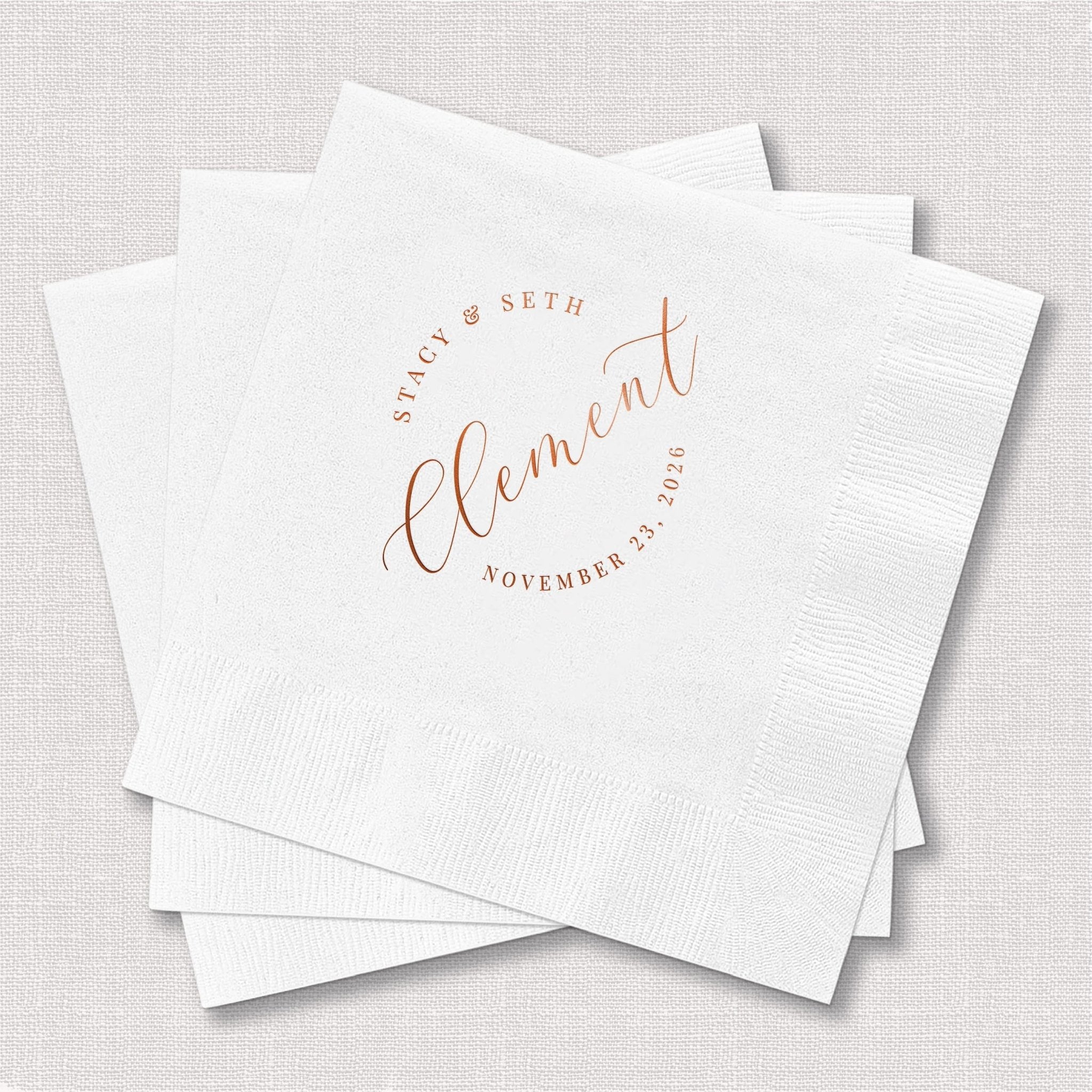 White cocktail napkins with rose gold foil stamped text reading "Clement" and "Spirit of Seth" with November 23rd date.
