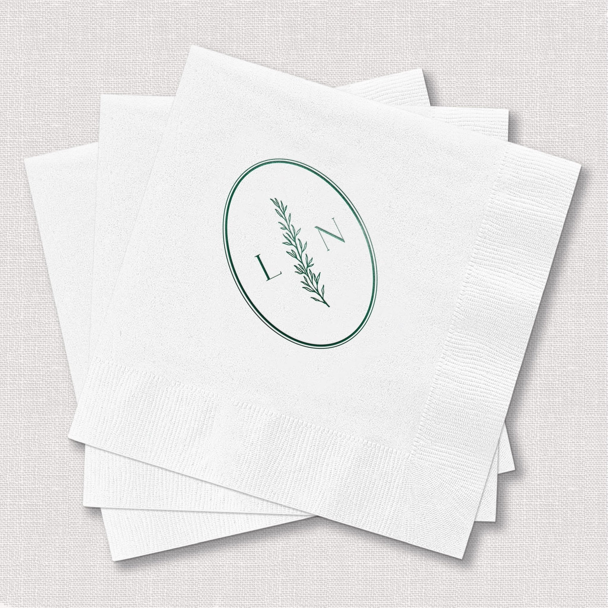 White napkins with sage green botanical oval monogram and initial design