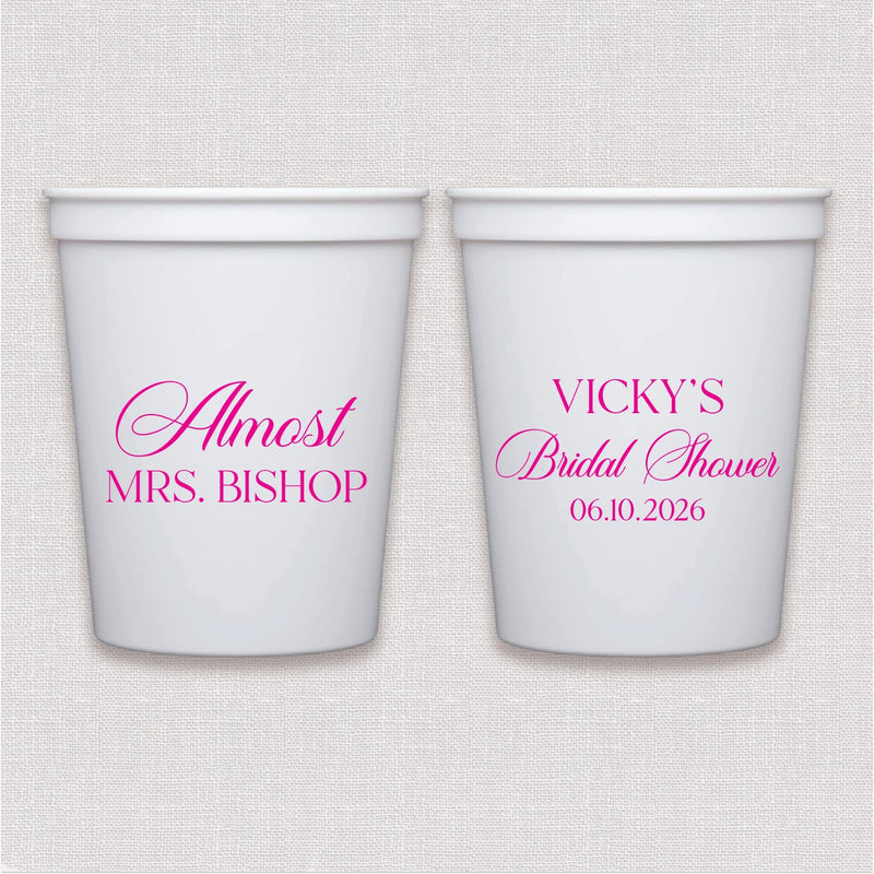 White stadium cups with hot pink bridal shower text and personalized wedding date design