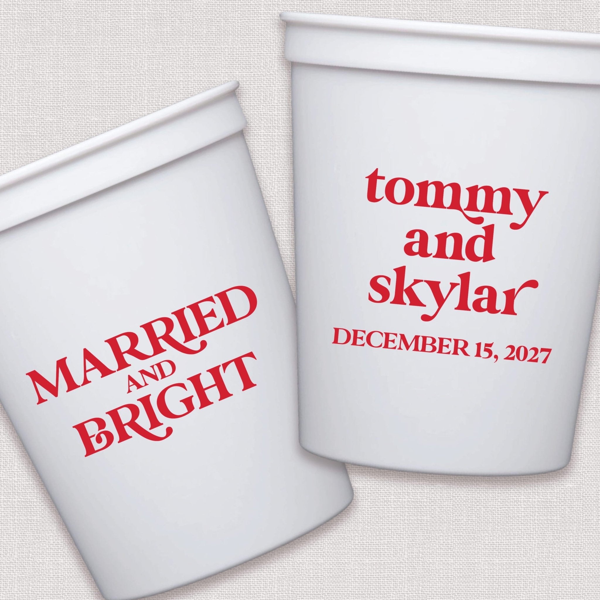 White stadium cups with red personalized wedding text and dates in modern script typography