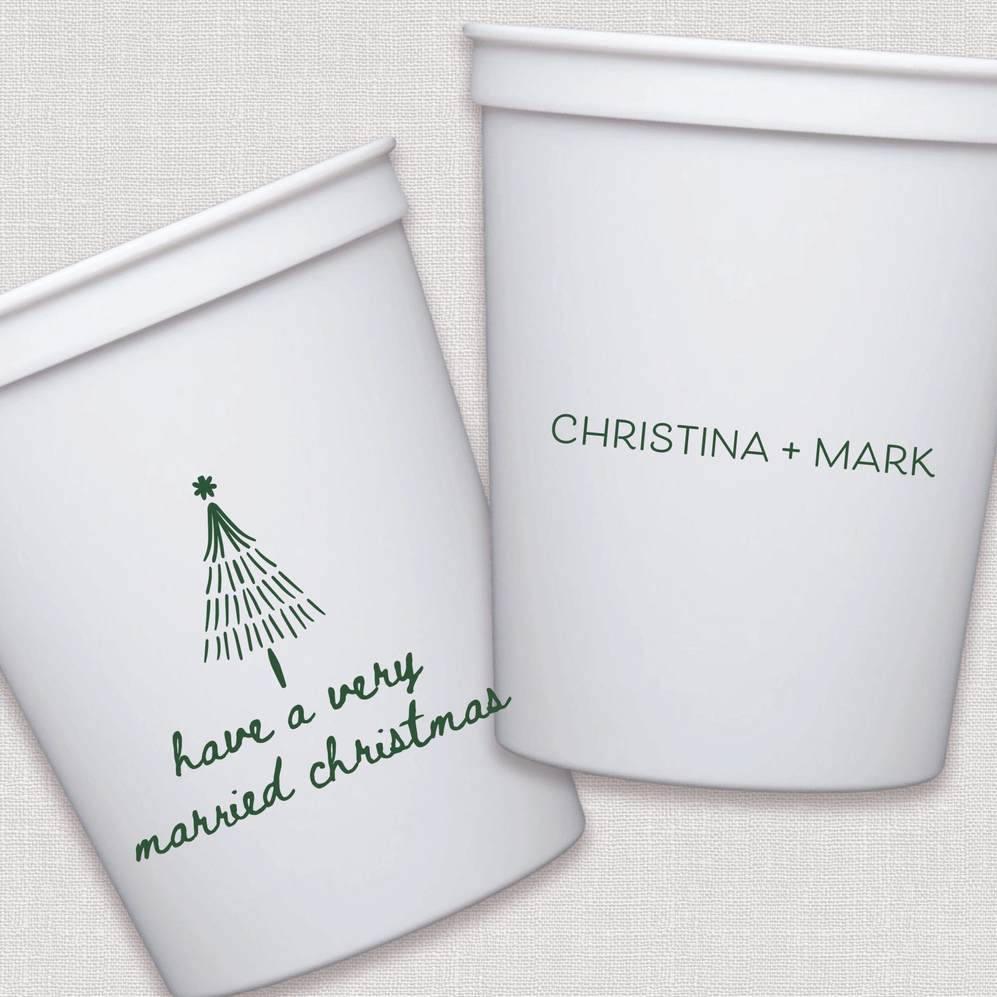 White stadium cups with personalized couple text and hand-drawn Christmas tree design