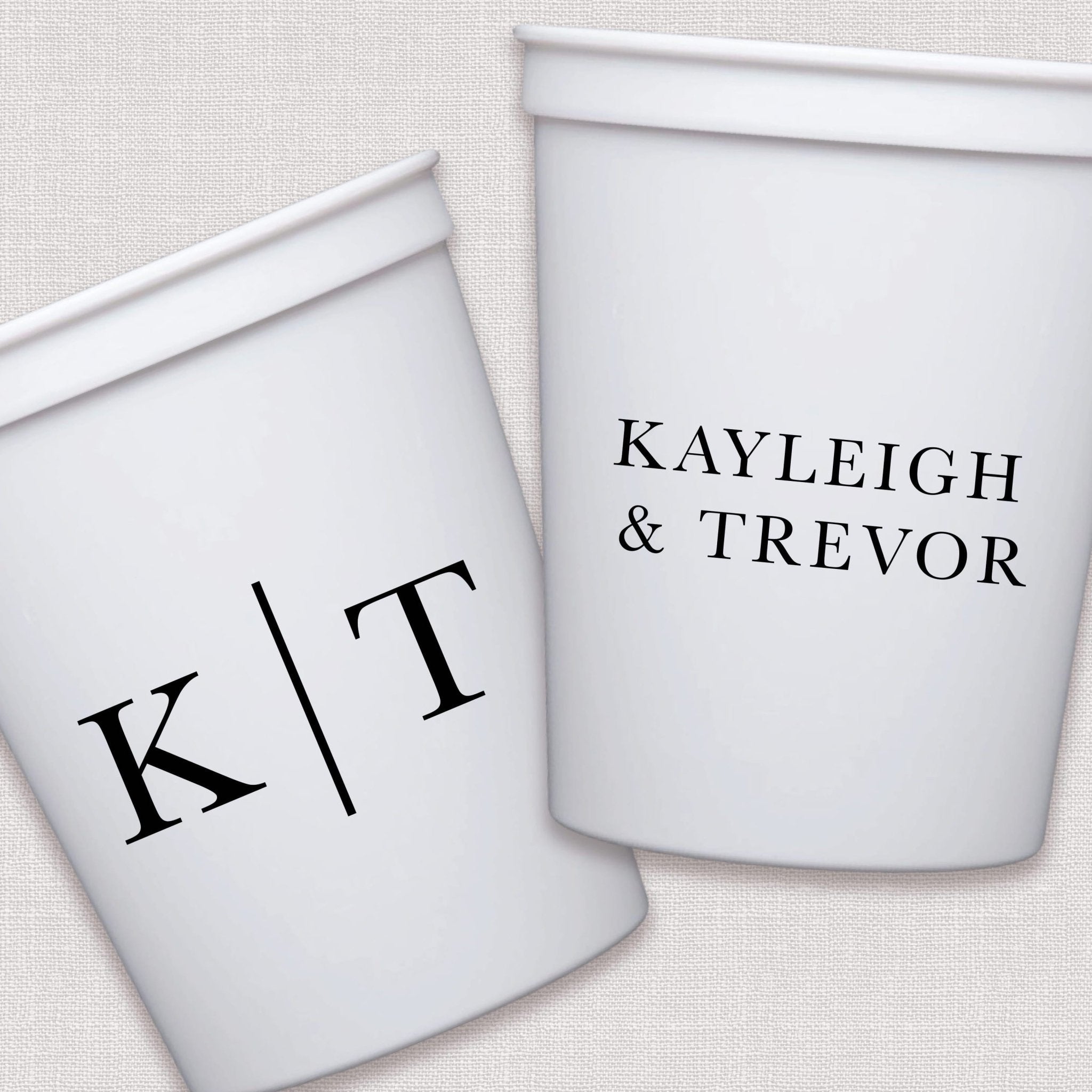 White stadium cups with personalized couple initials and names in elegant serif font design