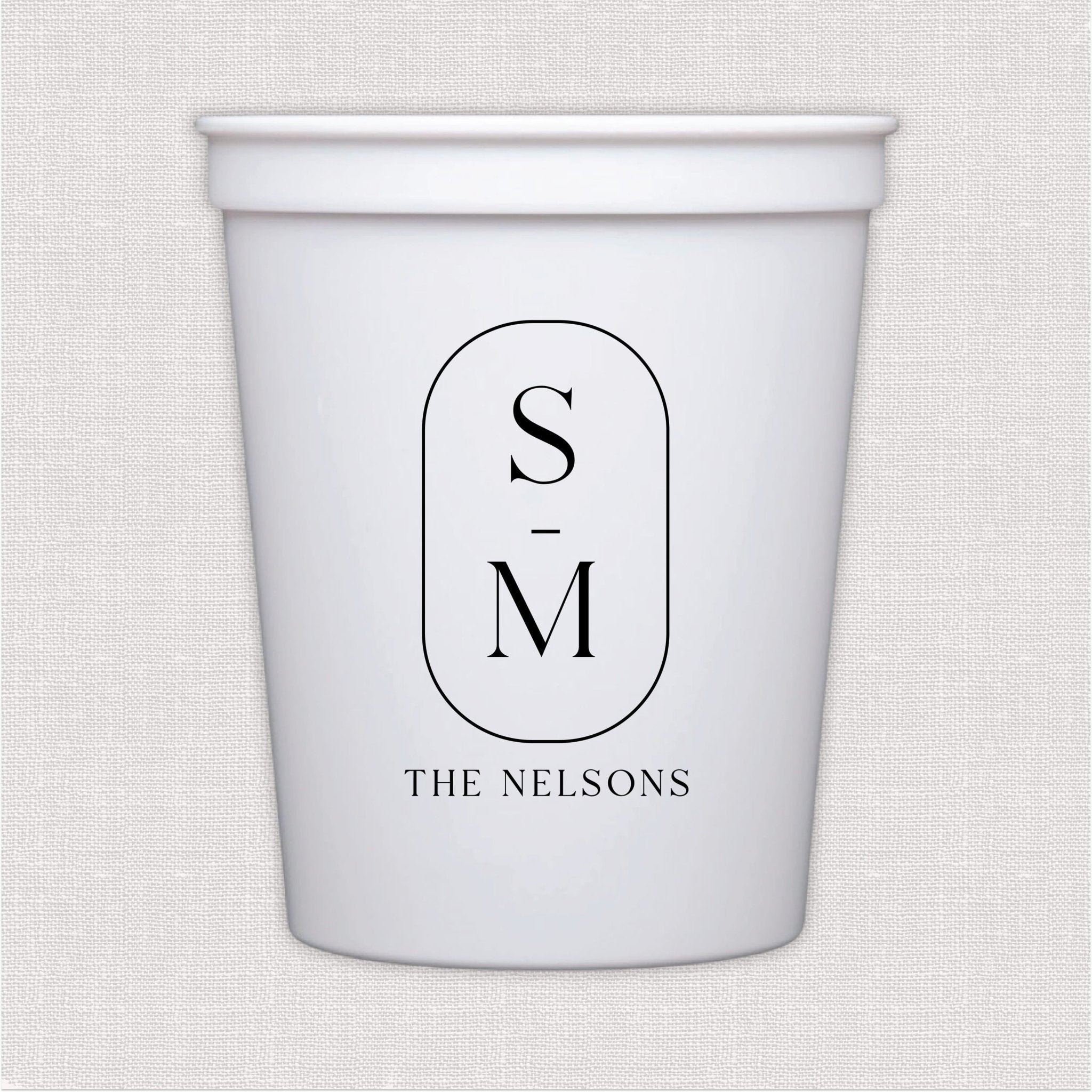 White stadium cup with monogram initials in oval frame and personalized last name text