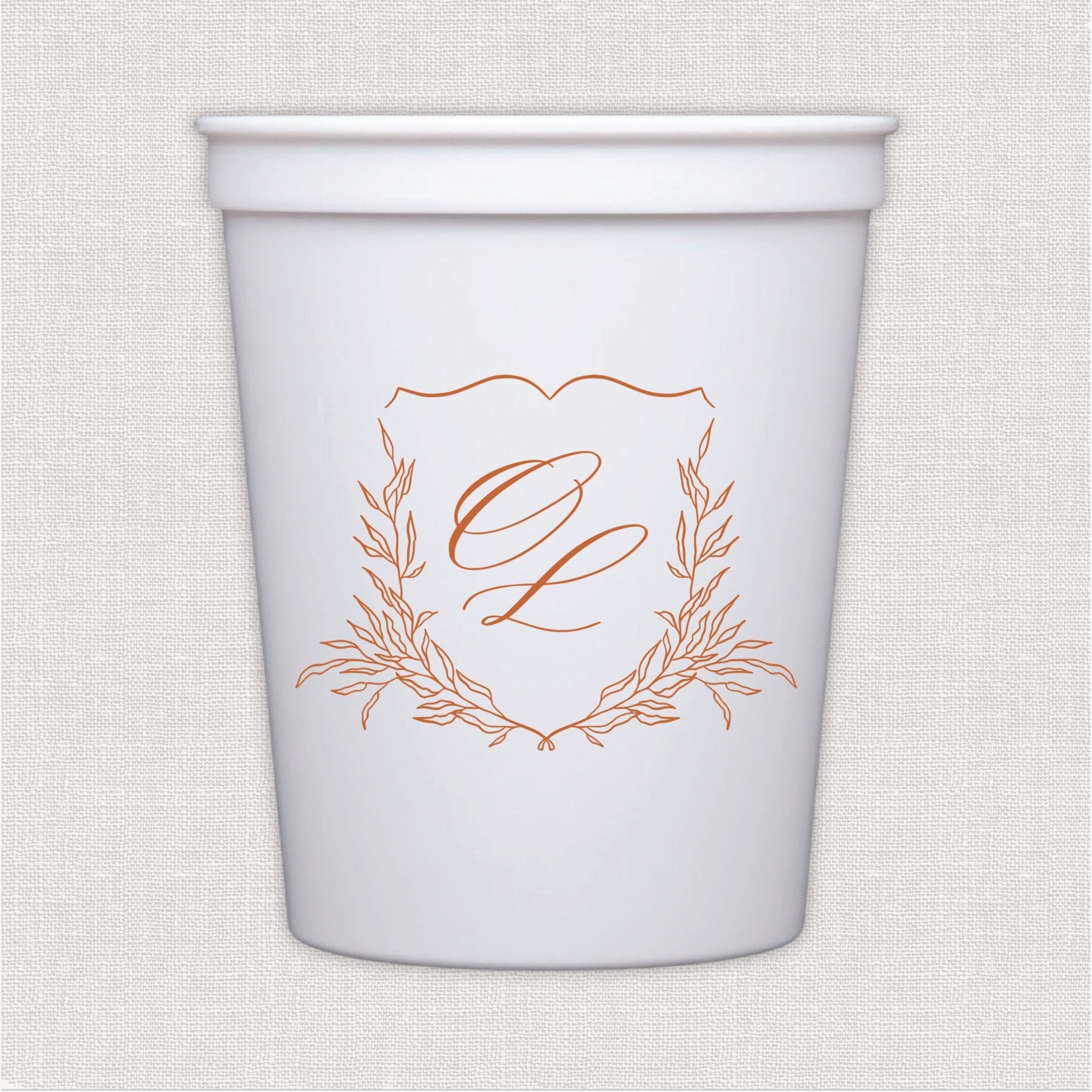 White stadium cup with coral script monogram and laurel wreath wedding crest design