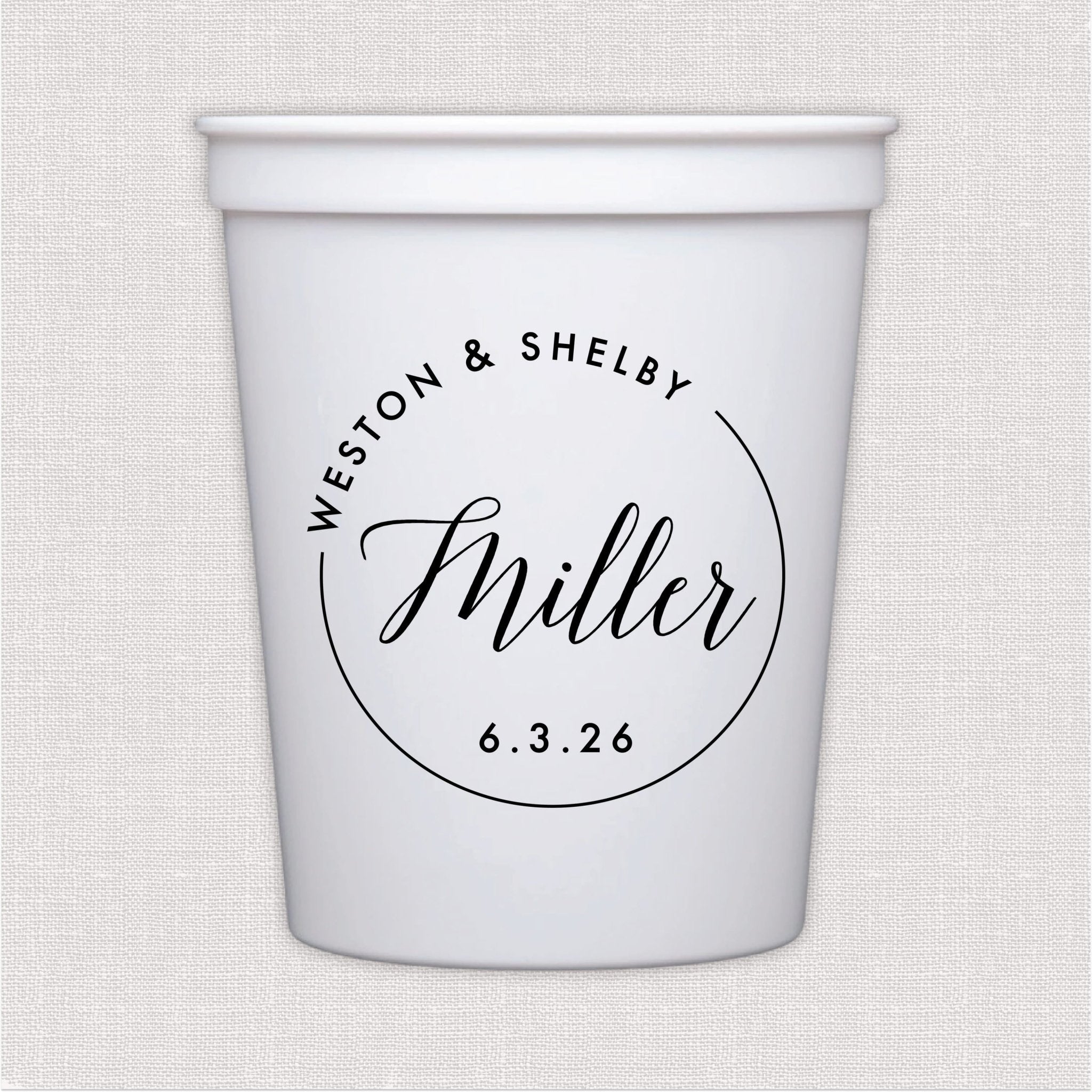 White stadium cup with black circular monogram design and personalized wedding text