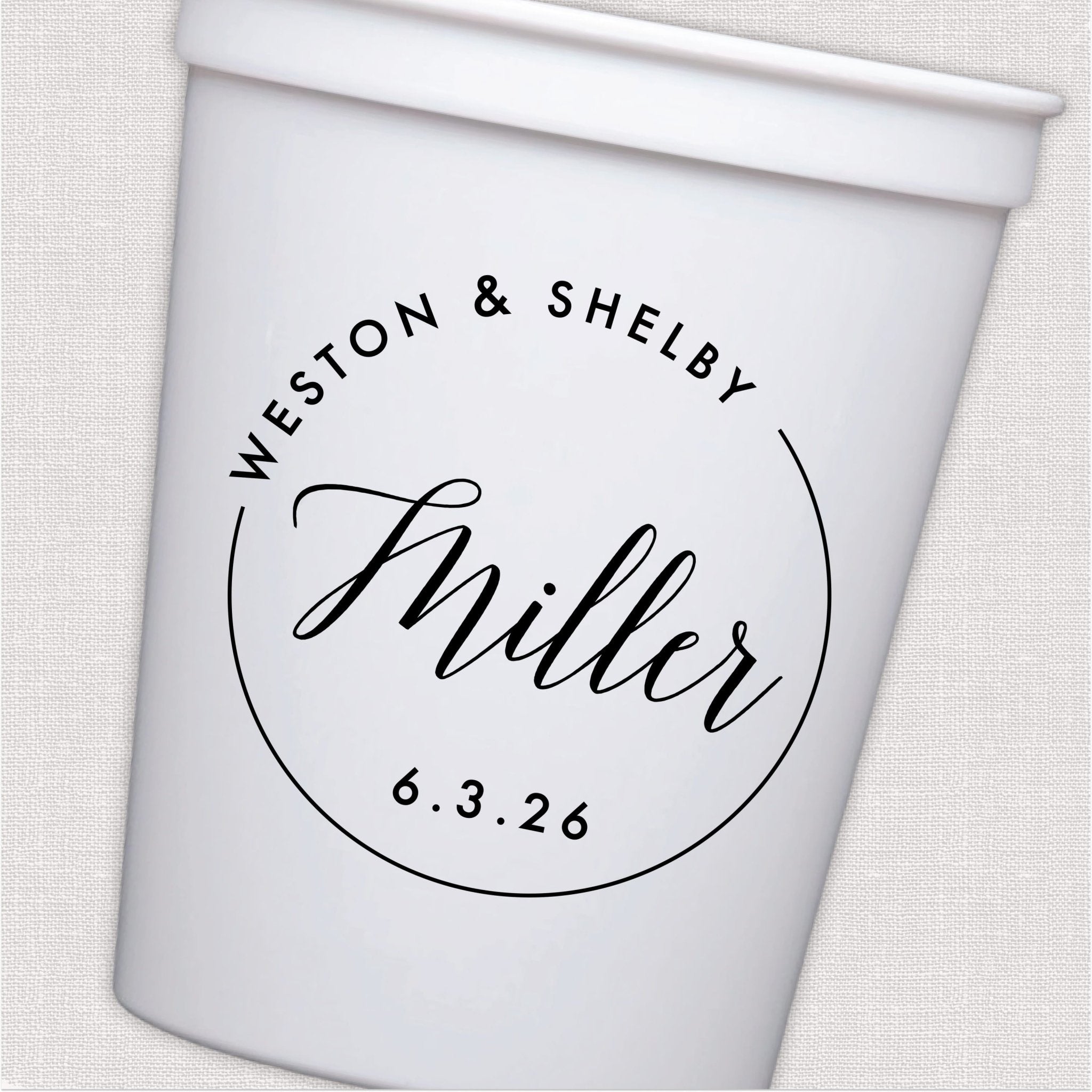 White stadium cup with personalized couple names in script and circular monogram wedding design