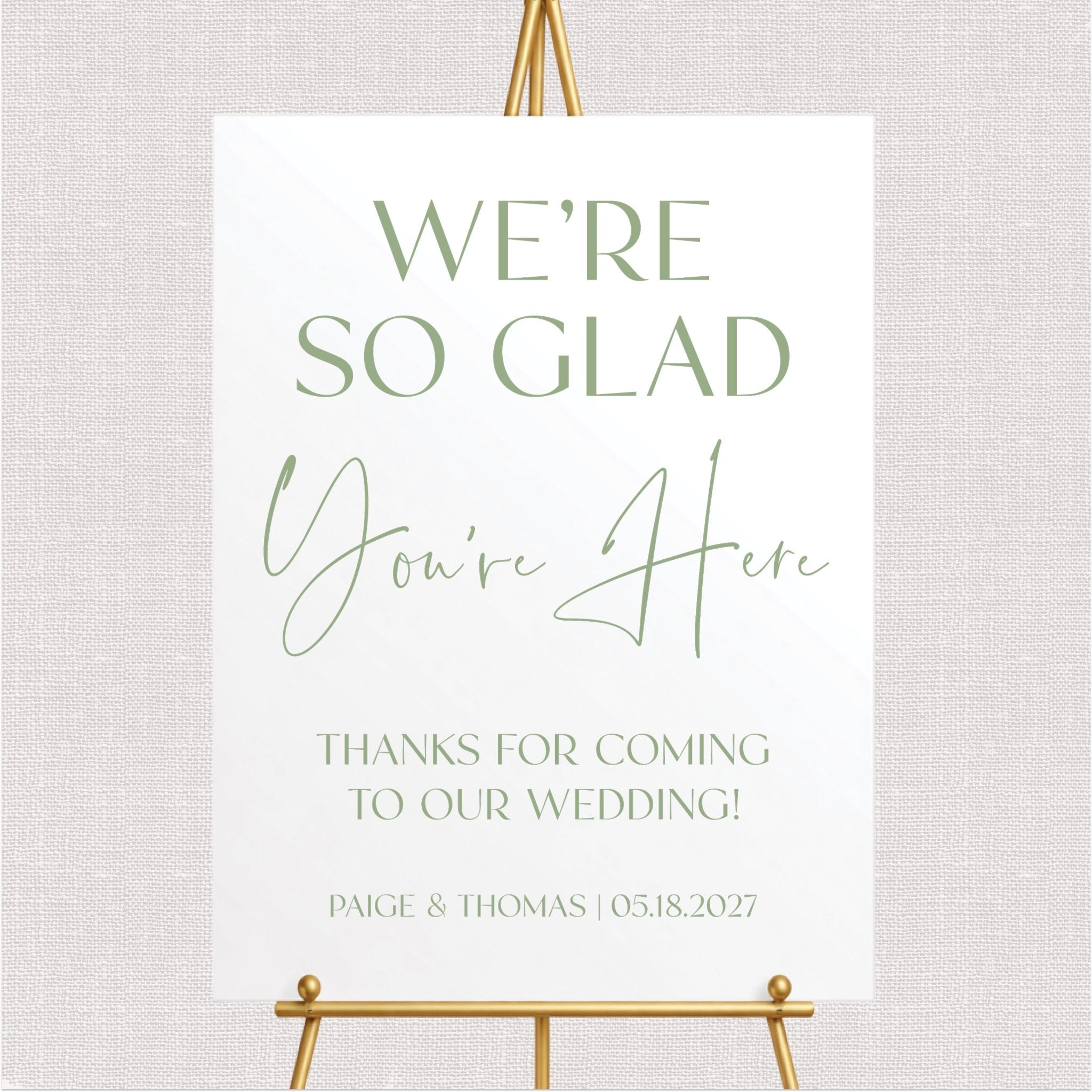 White wedding welcome sign with sage green personalized text and couple names, gold easel stand