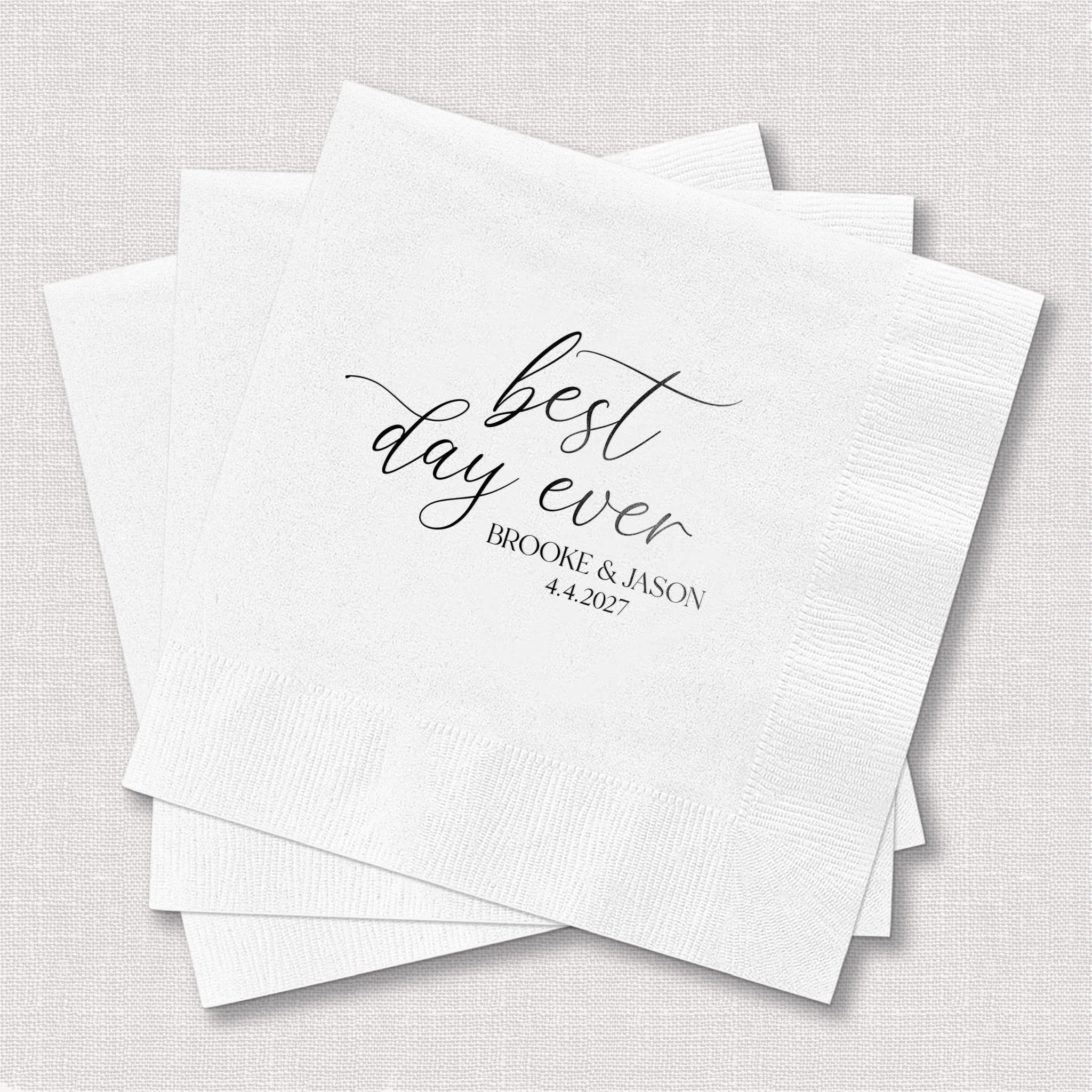 White foil-stamped napkins with "best day ever" in script and personalized names and date below in smaller text.