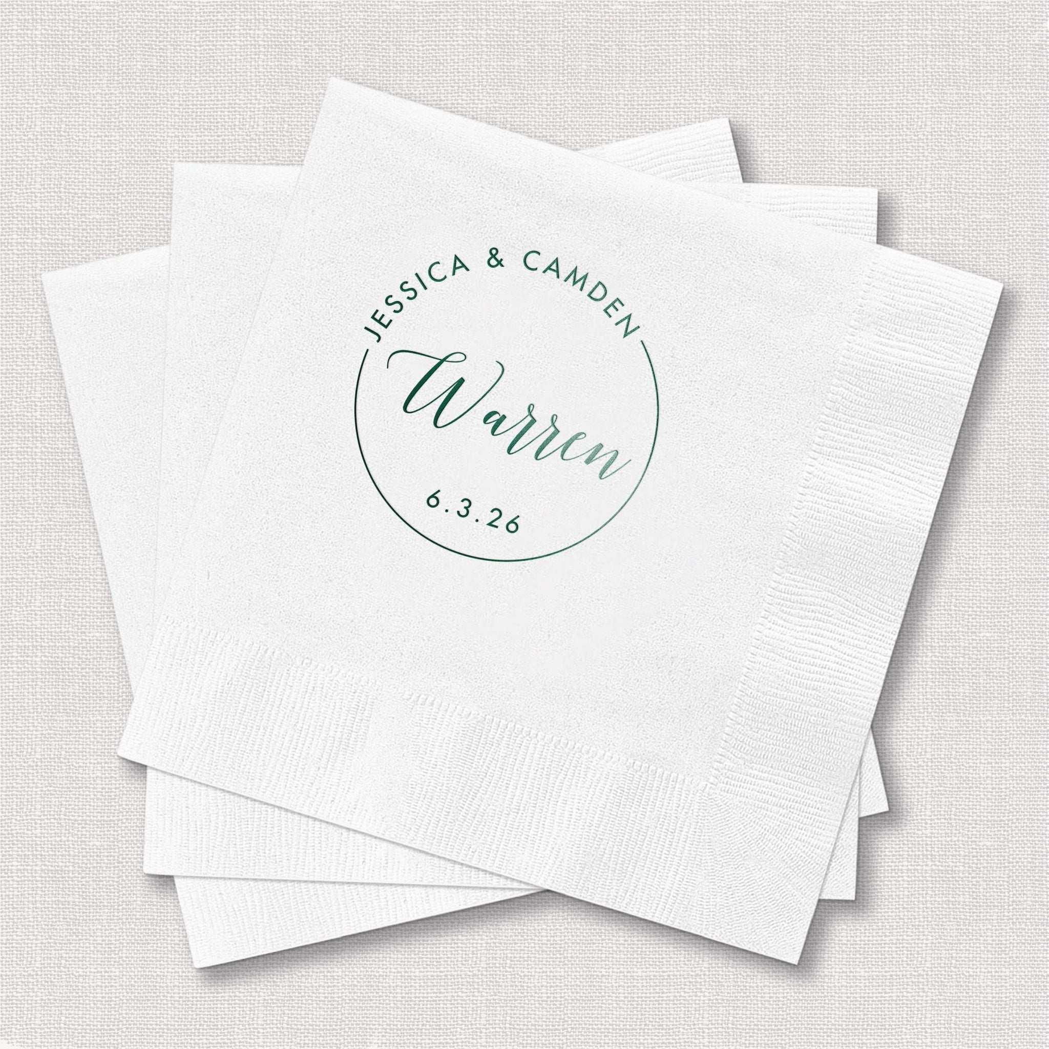 Stack of white personalized napkins with circular monogram design featuring names Jessica & Camden, last name Warren, and wedding date 8.3.24 in teal foil stamping.