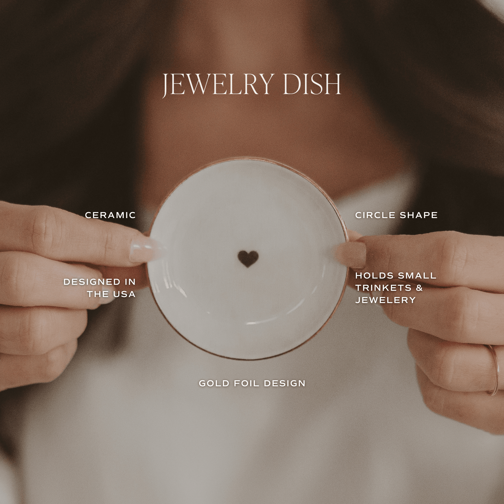 White ceramic jewelry dish with small gold heart design in center, held in hands, circle shape for trinkets