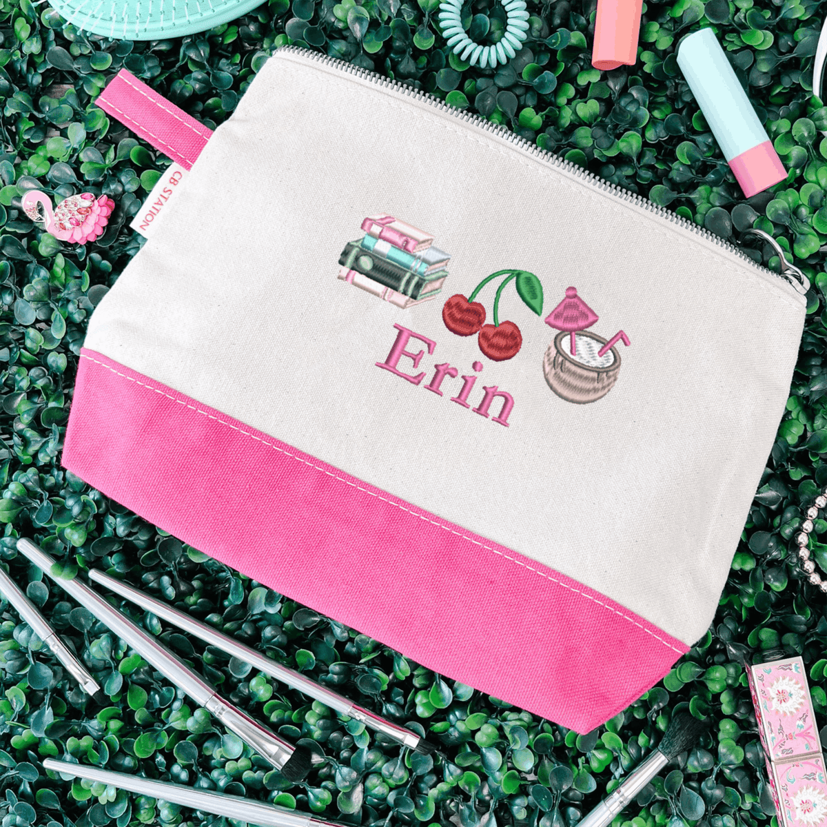 Embroidered makeup bag with pink trim personalized with the name Erin and colorful icons including cherries and a tropical drink