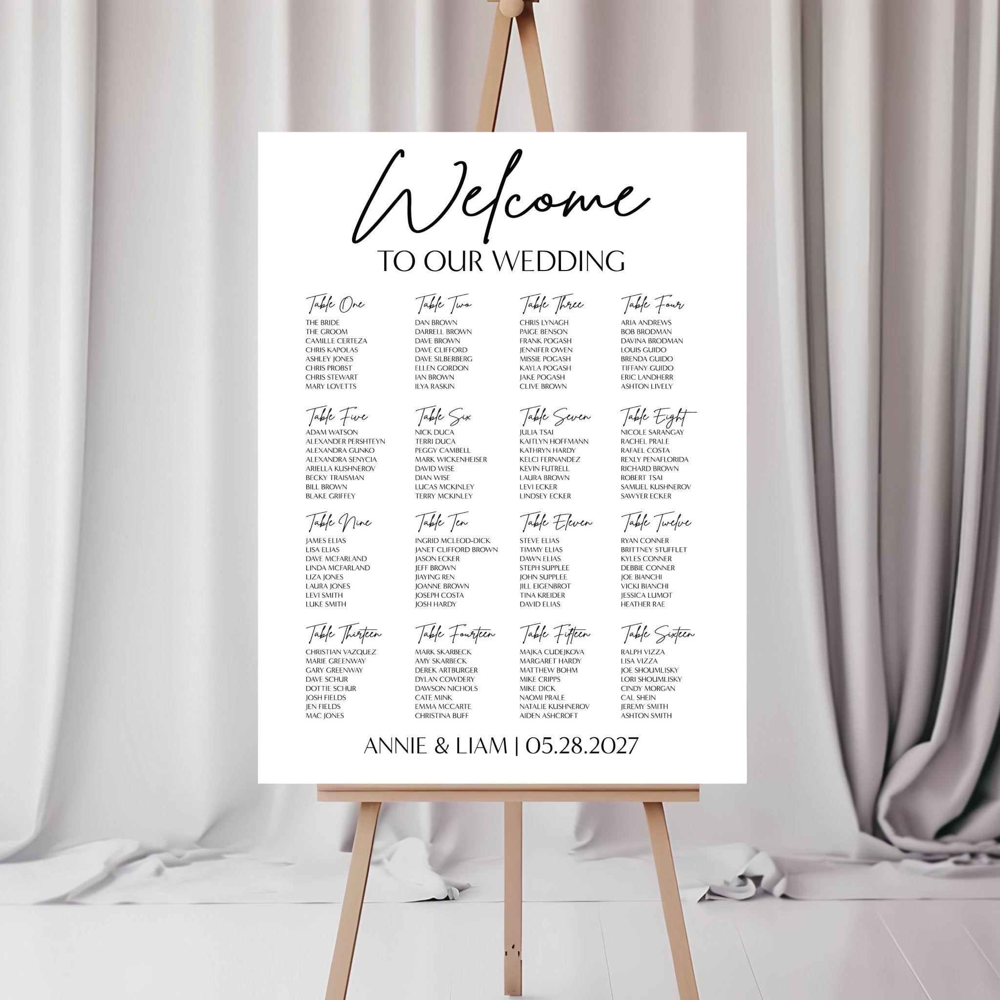 Large acrylic wedding seating chart listing tables and guest assignments