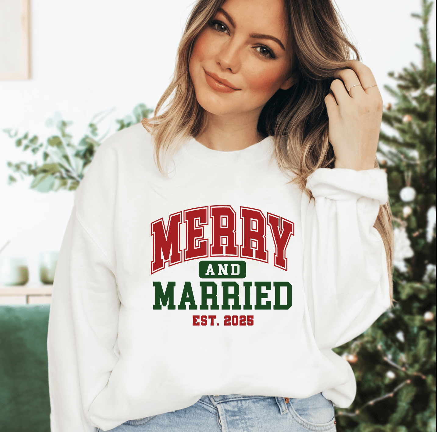 White crewneck sweatshirt with red and green varsity-style text reading "Merry and Married EST. 2025"