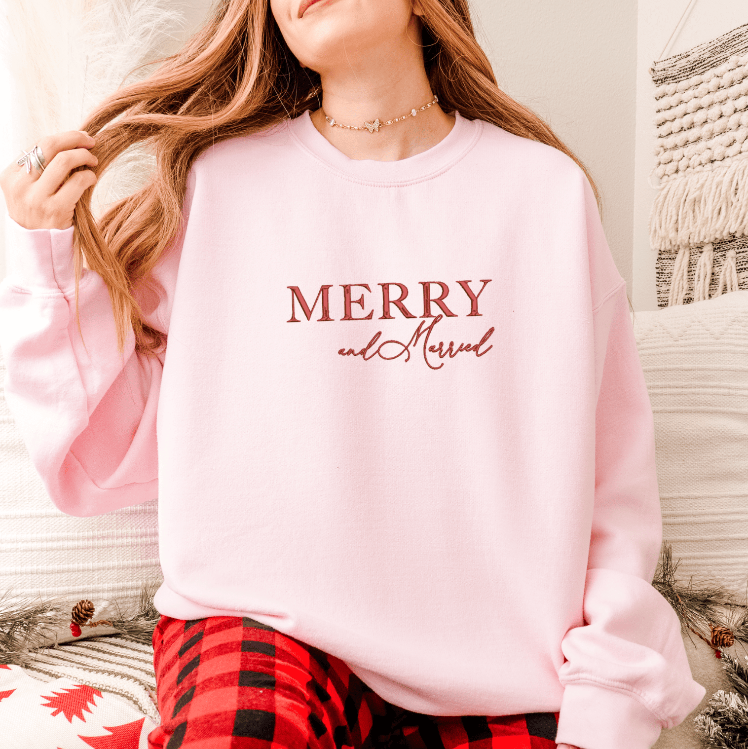 Light pink sweatshirt with "Merry and Married" text in burgundy lettering, styled with red plaid pajama pants.