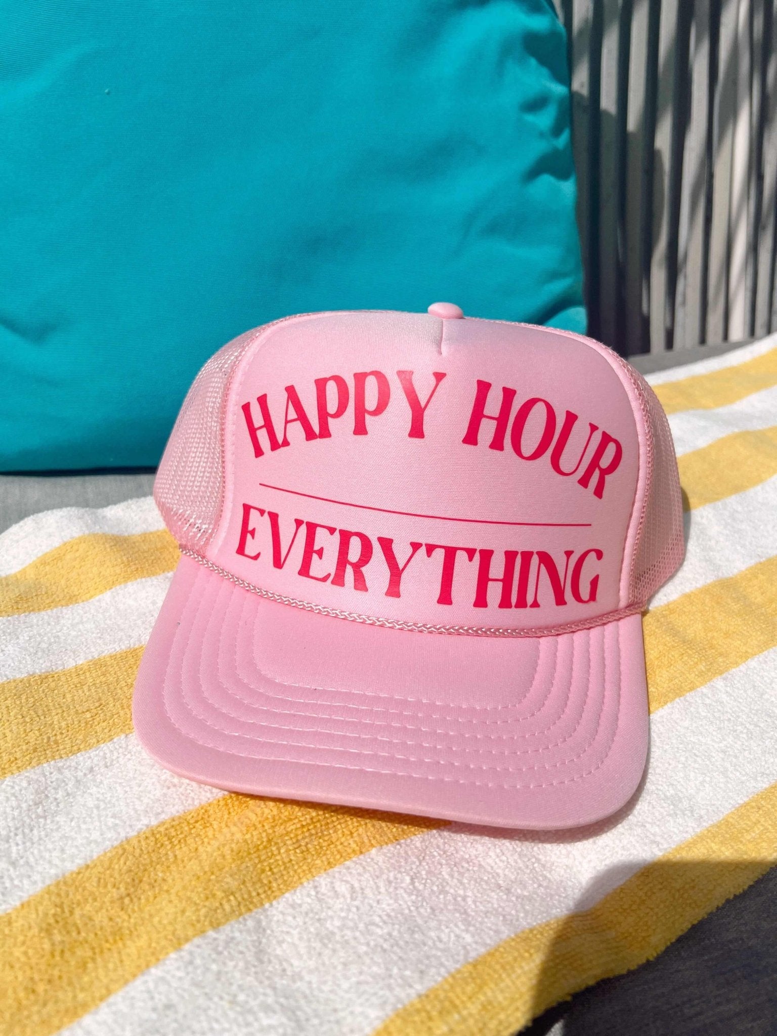 Pink trucker hat with "Happy Hour Everything" text in magenta on the front panel.