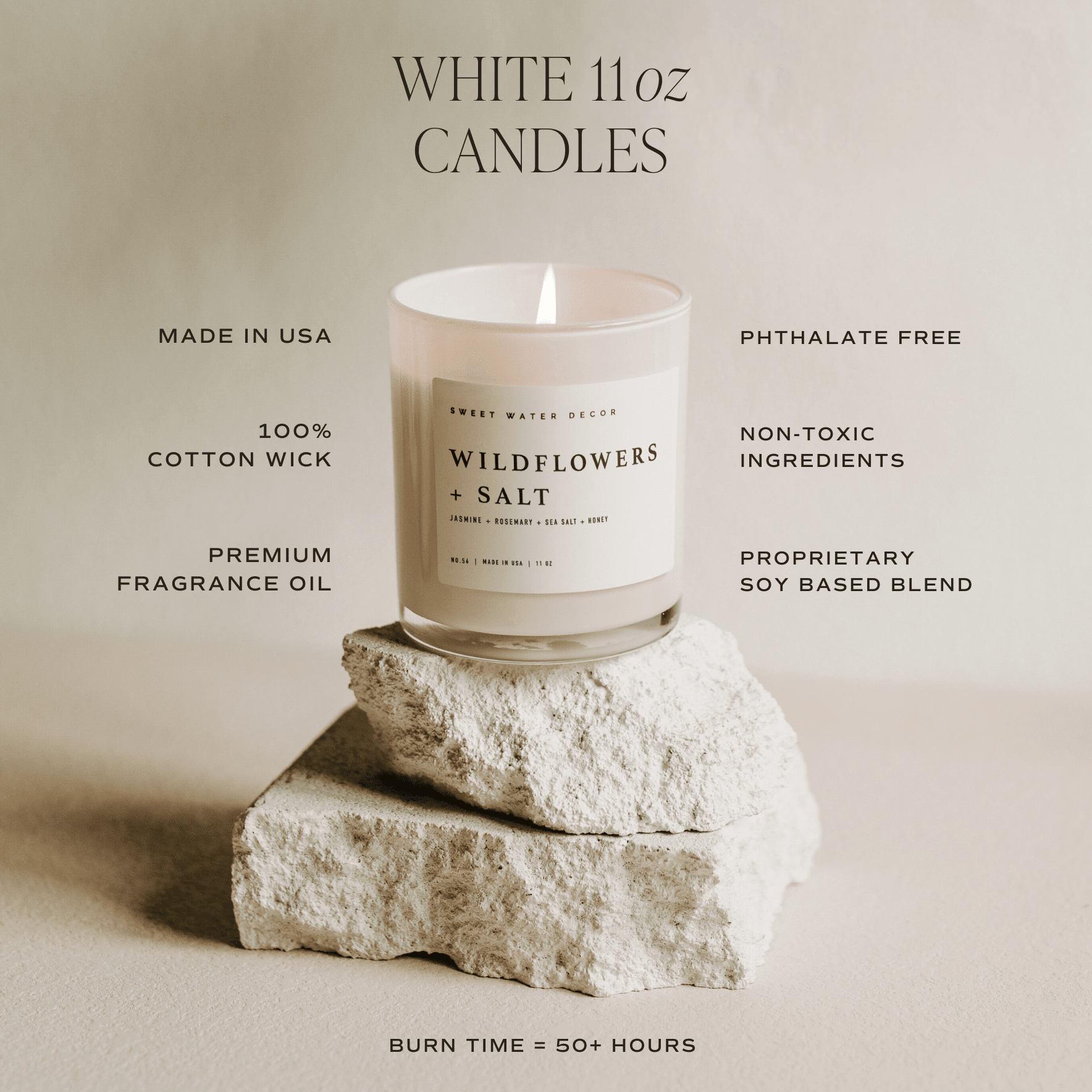 White 11oz soy candle in glass jar with "Wildflowers & Salt" label, displayed on white stone, highlighting cotton wick and premium fragrance oil features.
